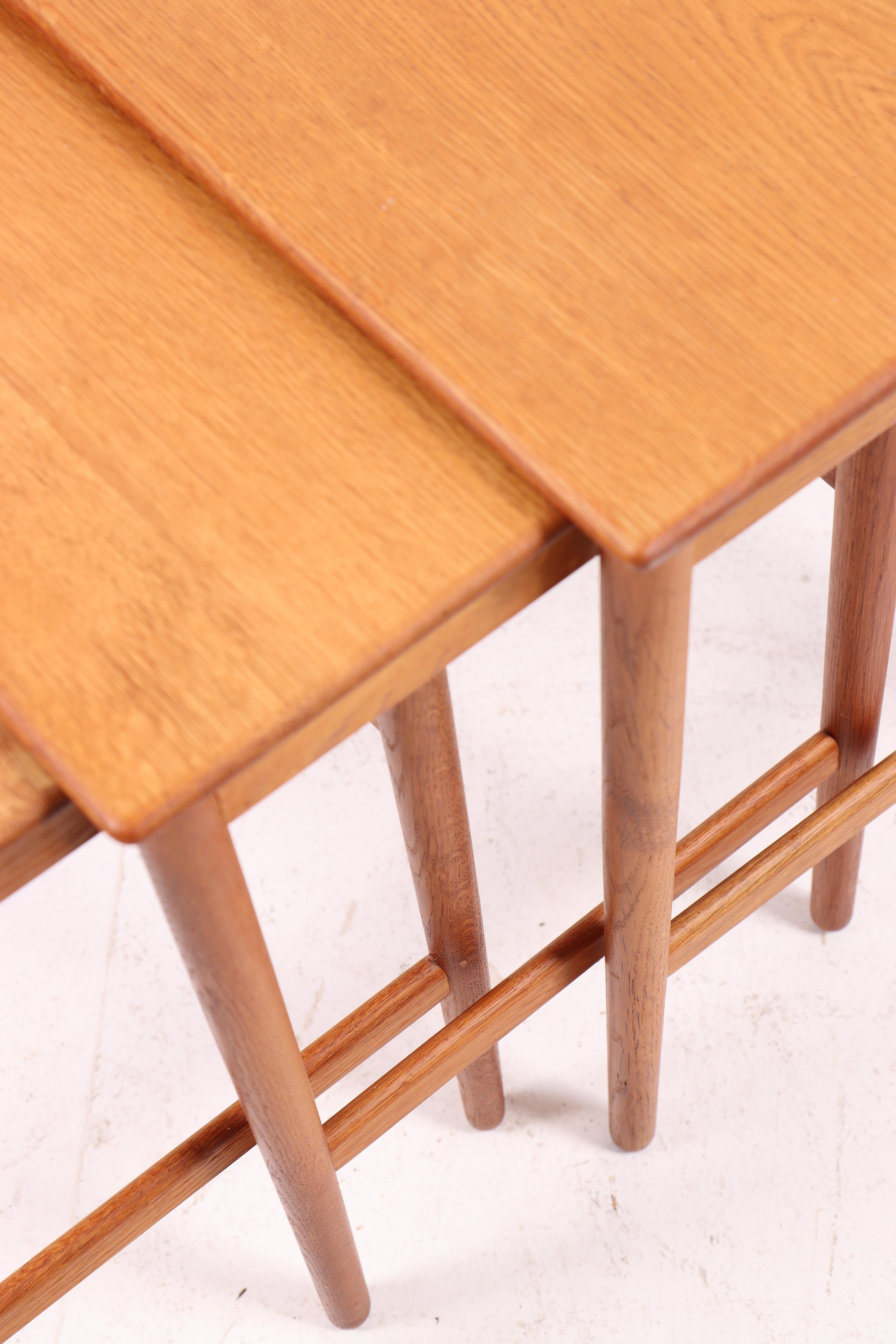 Set of nesting tables in well patinated finished Scandinavian oak designed by Maa. Hans Jørgen Wegner for Andreas Tuck. Great condition.