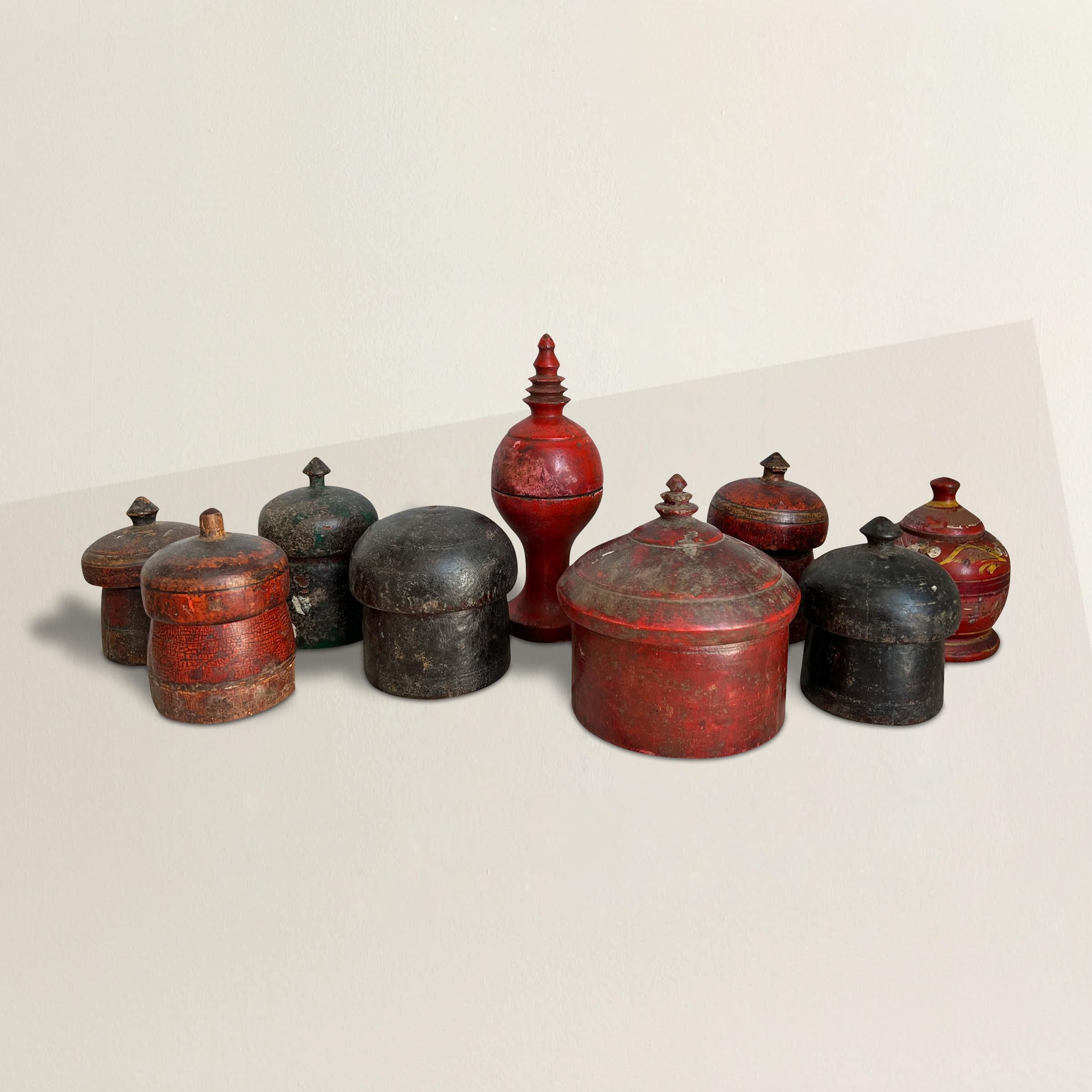 A wonderfully sculptural set of nine 19th century Indian hand carved red and black painted wood spice boxes perfect for storing all kinds of vices!

Largest: 4.5 in. diameter x 5 in. height
Tallest: 2.5 in. diameter x 7.5 in. height
Shortest: 3