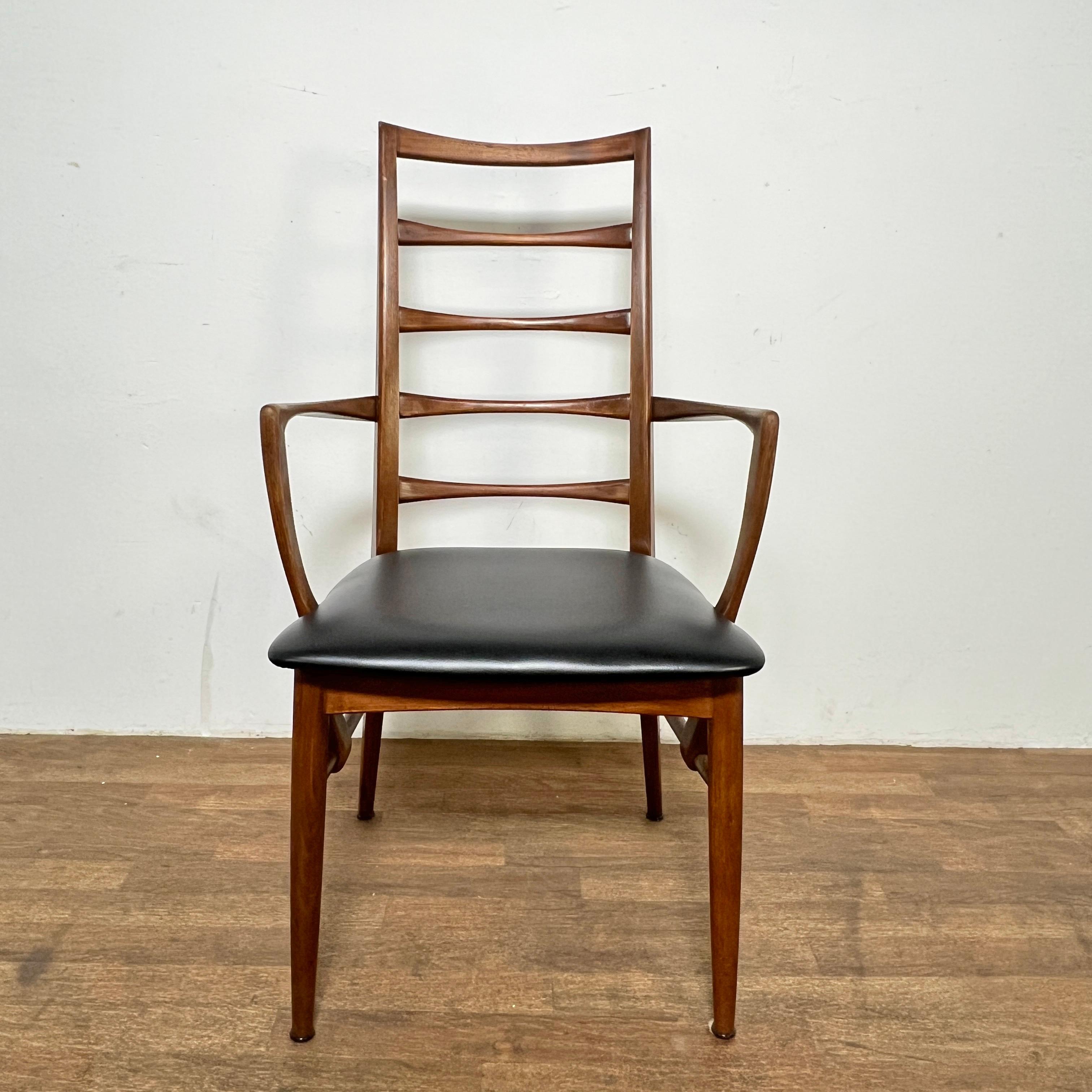 Set of nine high backed Danish teak “Lis” dining chairs by Niels Koefoed for Koefoeds Hornslet, ca. 1960s, featuring one armchair and eight side chairs.

Armchair measures 21.75