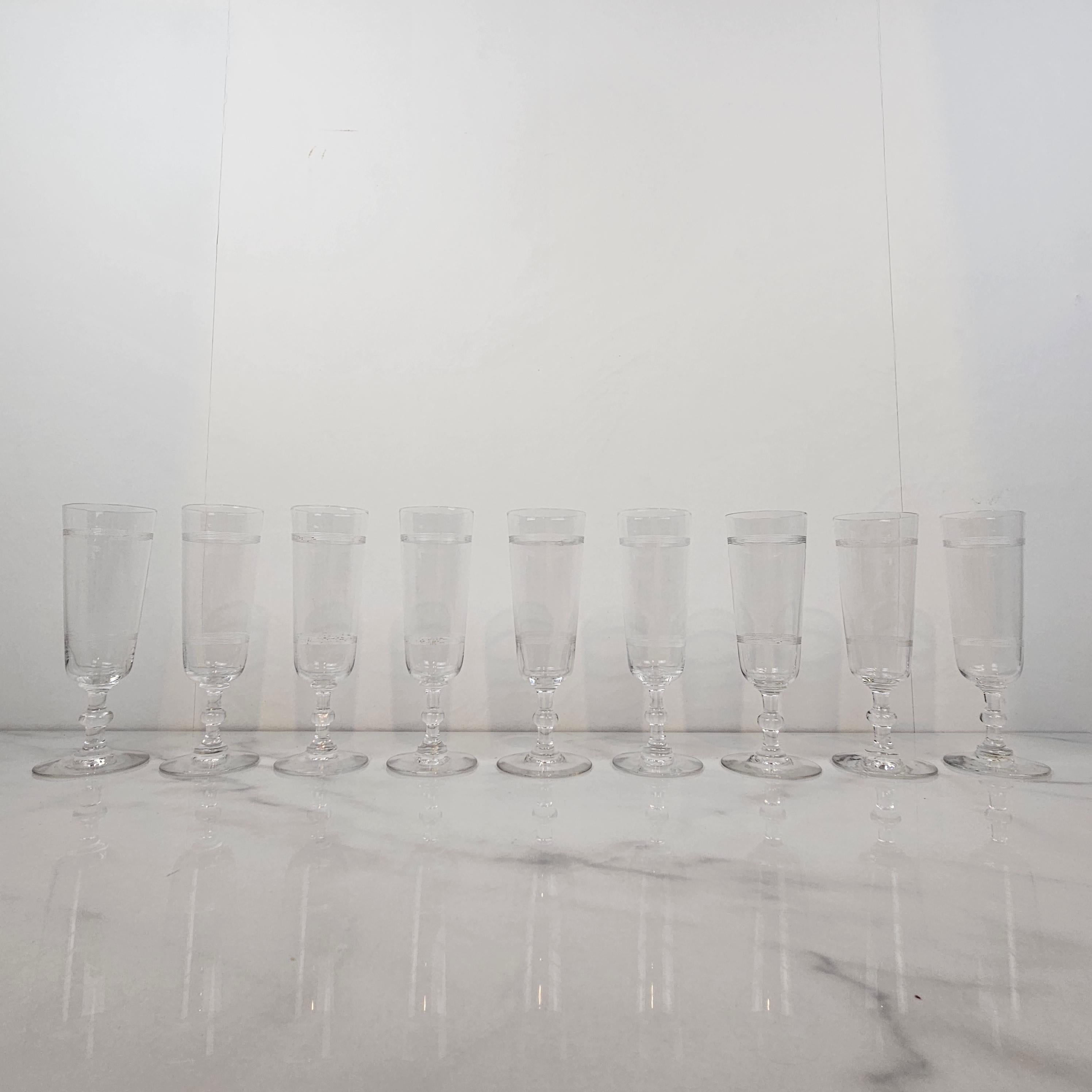 A beautiful set of nine handmade French Champagne flutes in crystal glass, fabricated around 1890.  

These antique glasses are mouth-blown. 

Please take notice of the very nice details and the elegant design.
Meticulously handcrafted, these