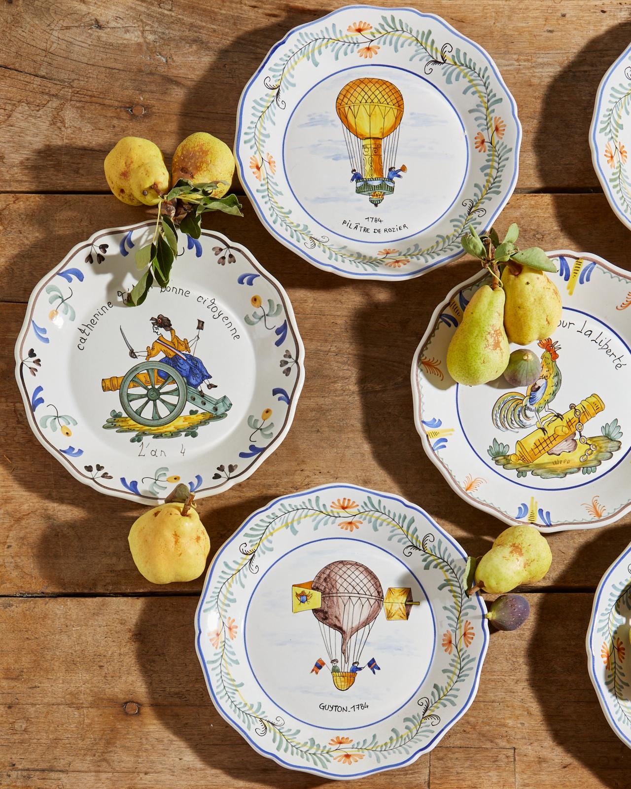 Charming set of nine French Provincial style Faience dinner plates. Each hand painted with scenes of balloons, figures, and a rooster. Dated with 18th century dates on front and motifs. Labeled on backs made in France.