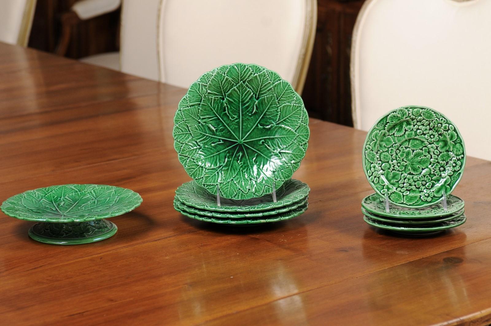 A set of eight porcelain plates and a compote from the 20th century, with green glaze and foliage motifs. Created in France during the 20h century, this set of nine pieces total (four large plates, four small ones and a single compote), captures our