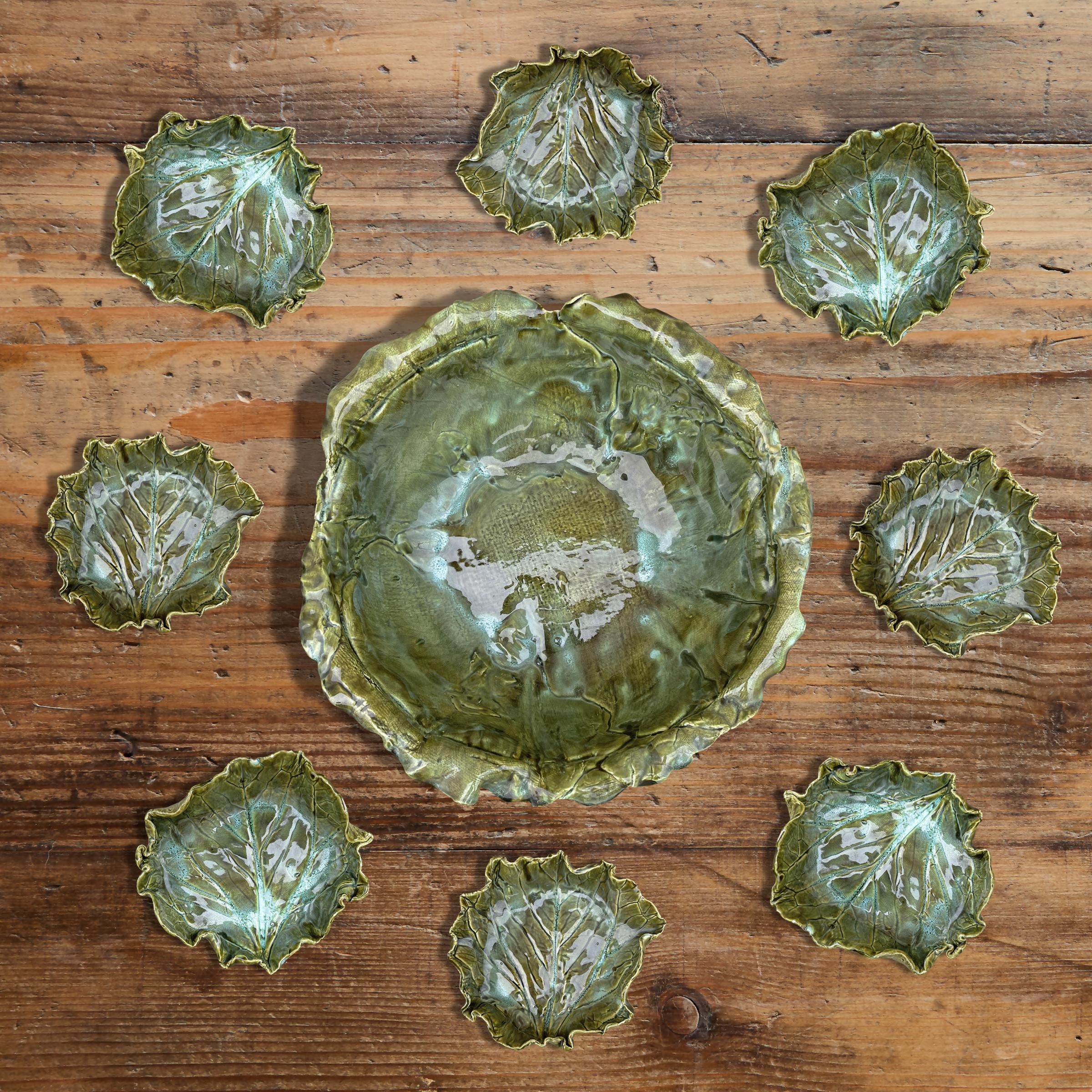 A wonderfully charming set of nine American hand-built ceramic bowls, one large and eight small, with beautifully rendered leaves and active chartreuse and turquoise glaze. The perfect set for serving appetizers at your next garden party, or