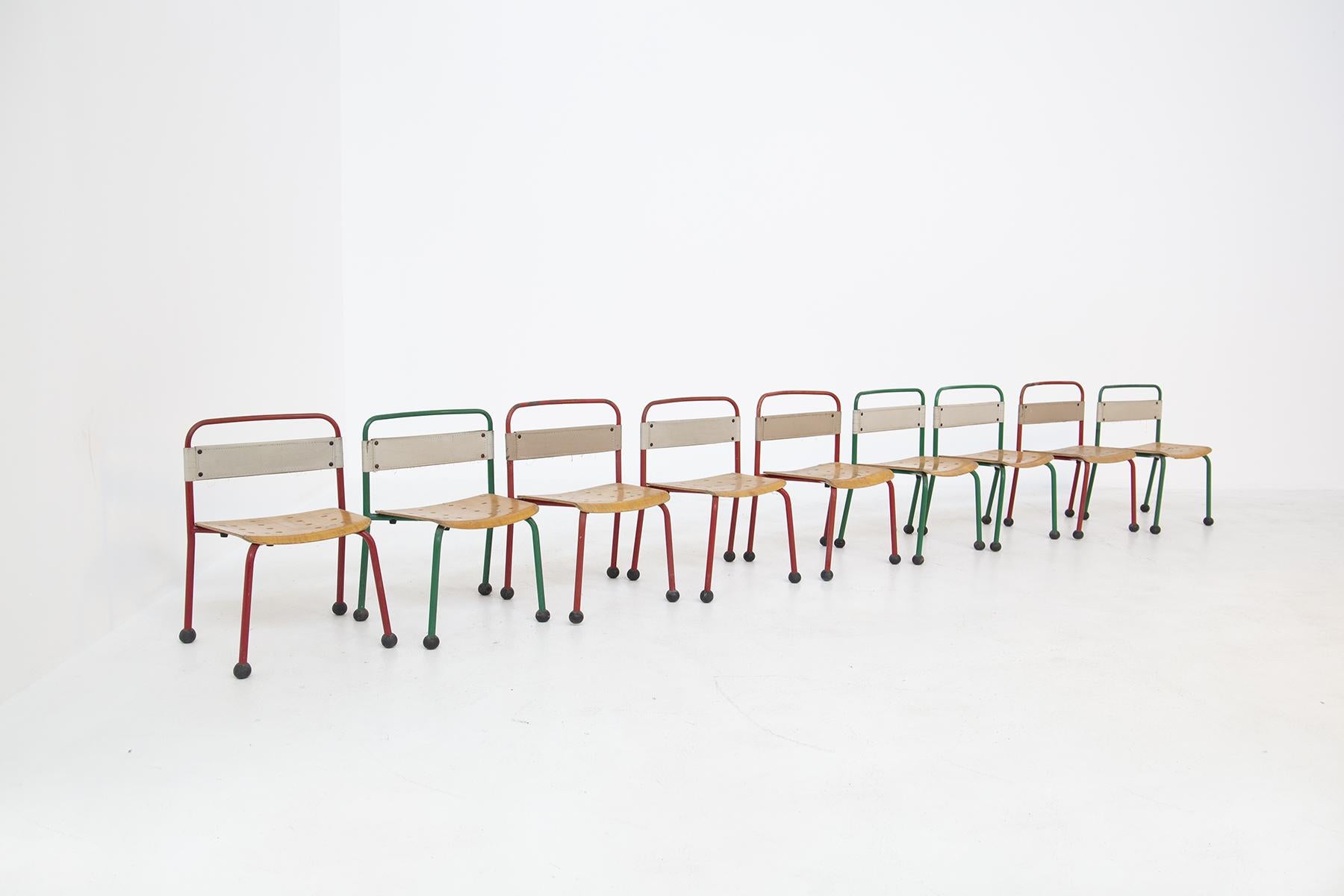 Lovely set of nine children's chairs from the 1970s. Set is made of tubular aluminum frame painted in red or green paint. The seat of the small chairs are made of wood with circular holes. French manufacture. The back of each chair is made of white
