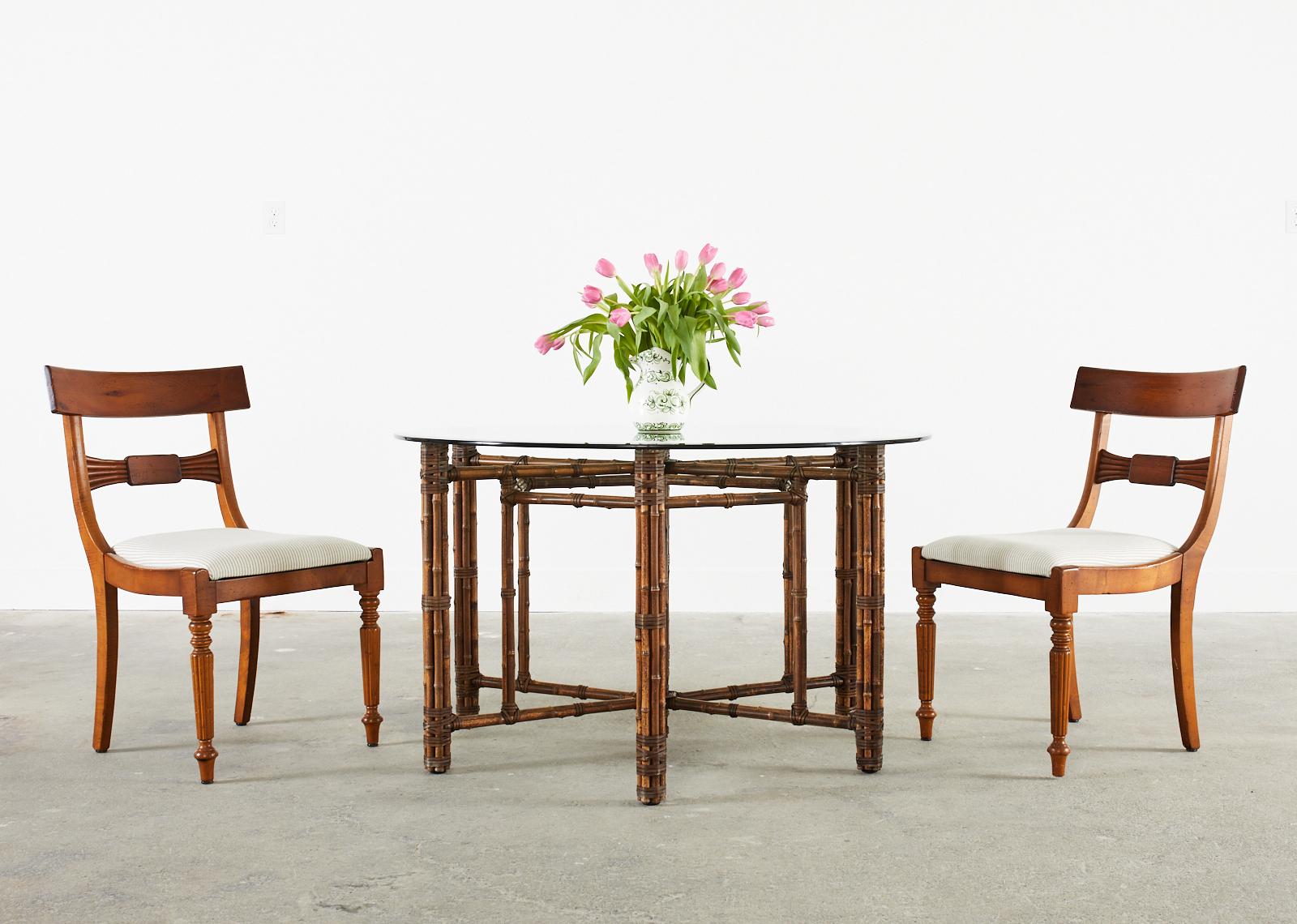 Fantastic set of nine Italian dining chairs made in the regency taste by Baker Milling Road. The chairs feature generous wood frames with a rich finish and a subtle intentionally distressed patina. The seats have a wide tablet backrest with a bow