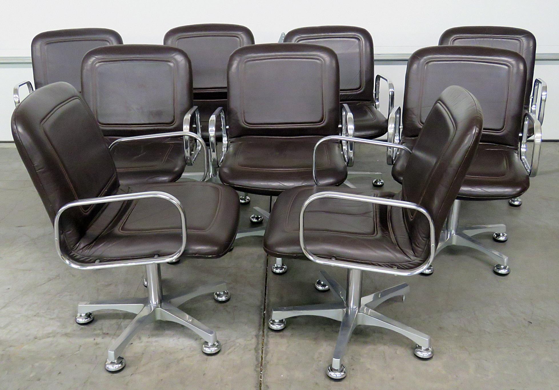 Set of nine Mid-Century Modern office chairs with chrome frames and distressed leather upholstery.