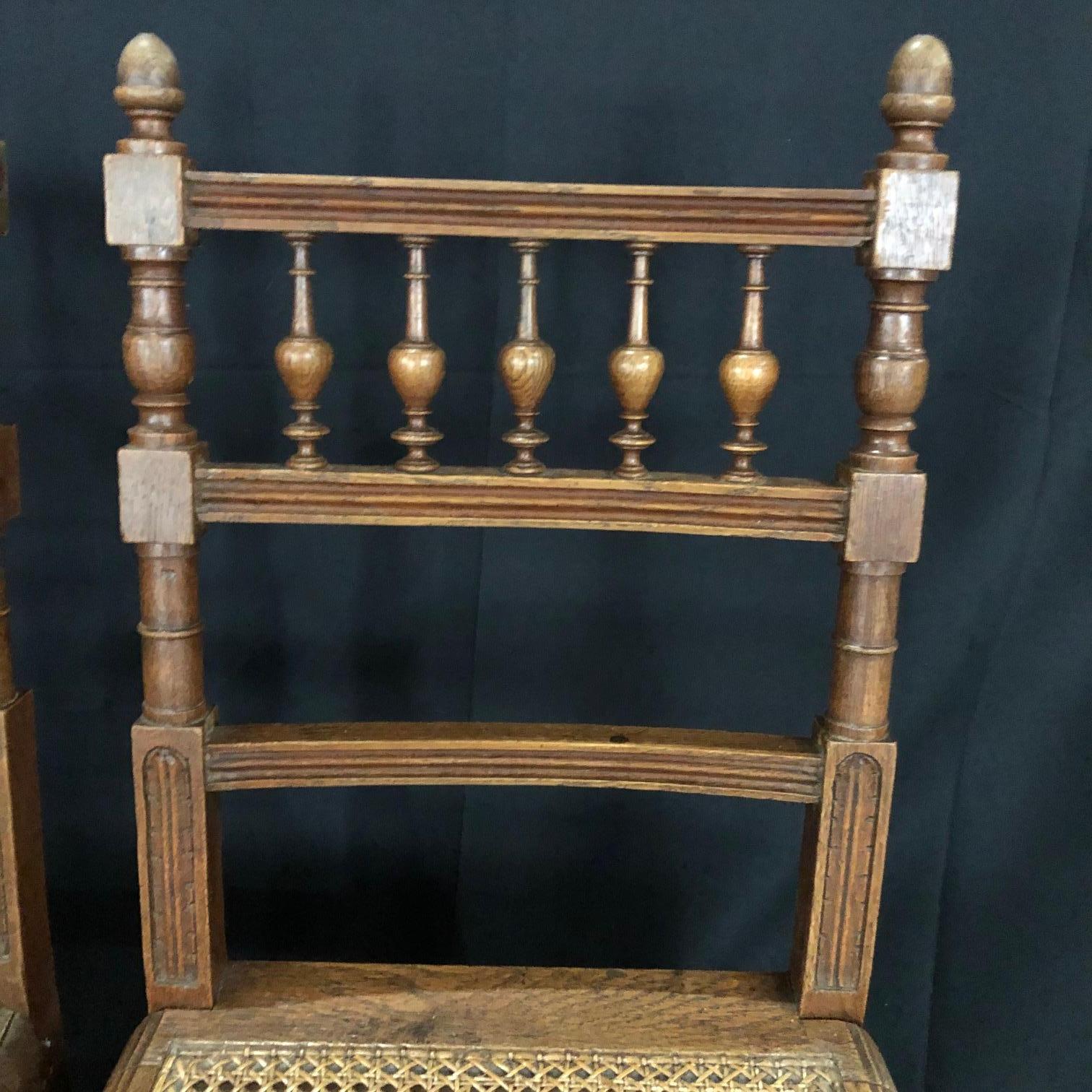 Beautiful and immaculate set of nine dining chairs from Normandy, France! These oak Henri II chairs have caned seats, all in great condition. The carving on each chair is detailed, with the ladderback accentuated with stunning carved spindles,