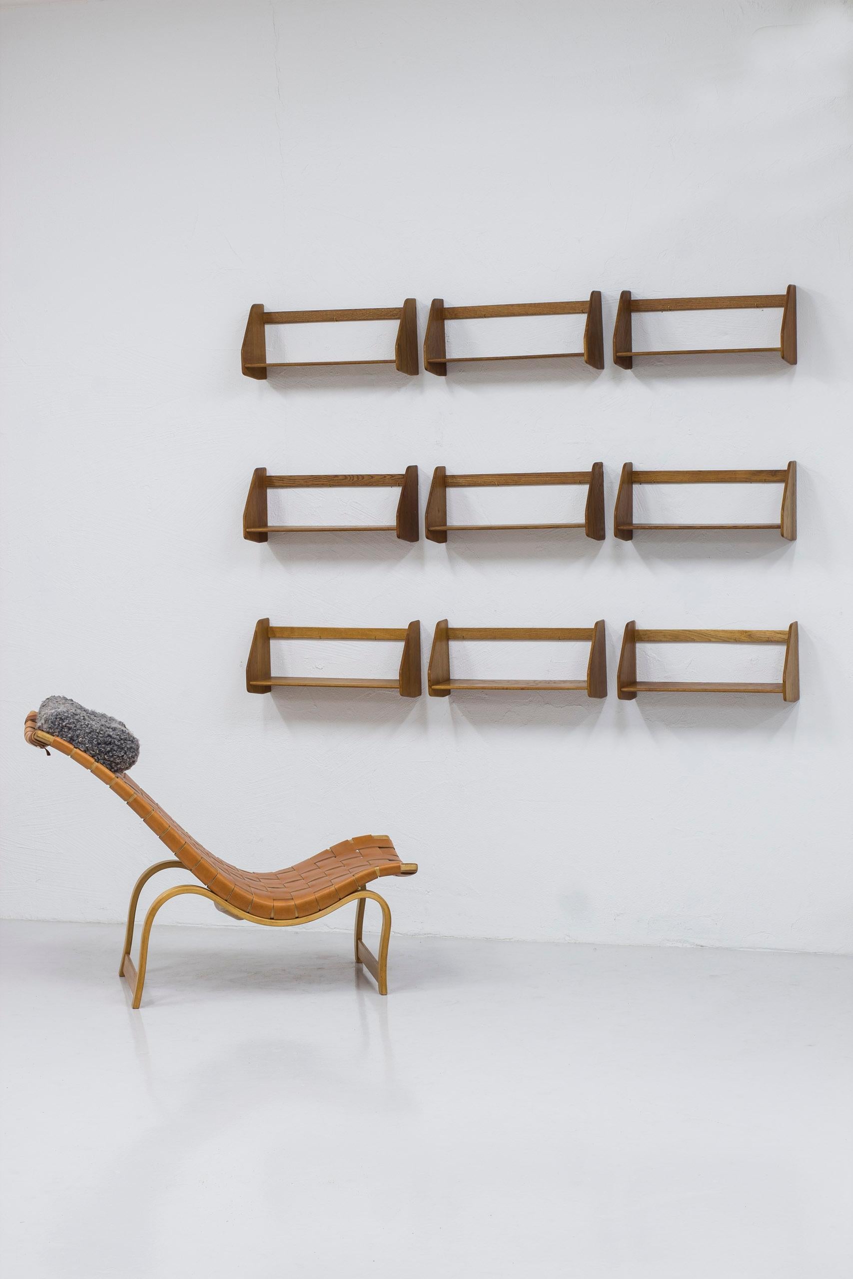 Set of nine shelves model RY21 designed by Hans J. Wegner. Produced in Denmark by RY Møbler during the 1950s. Made from solid oiled oak. The back pieces have not been screwed through which is very common. Instead the shelf is hung on small brass