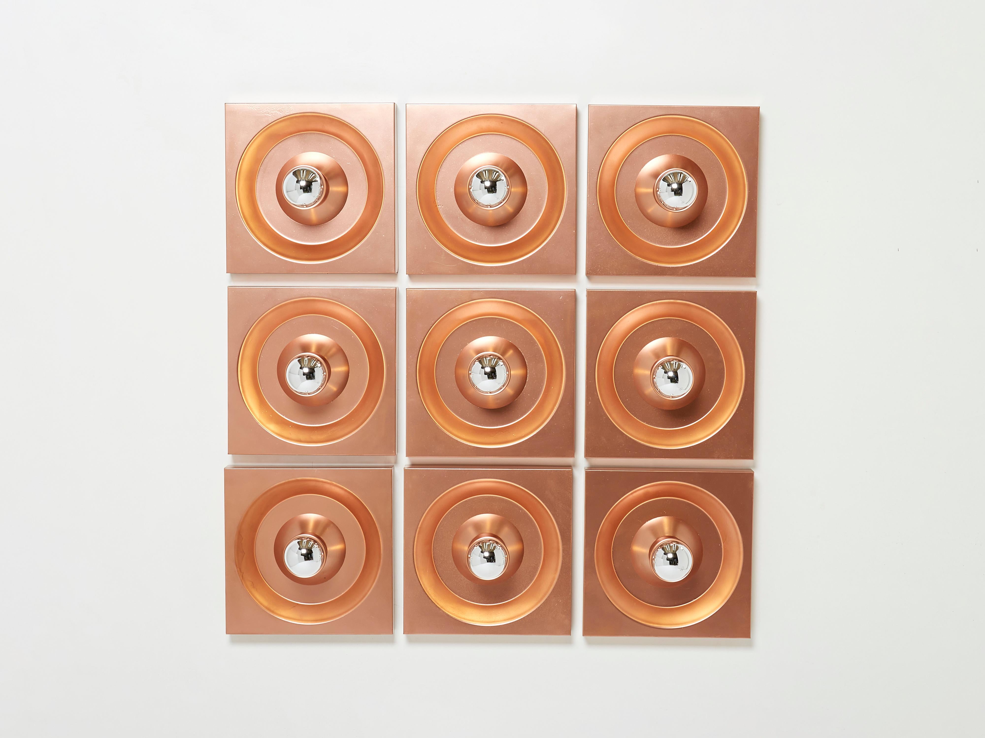 This is a rare set of 9 original copper coating wall lights designed by Klaus Hempel and produced by Kaiser Leuchtenin in Germany in the 1960s and 1970s. These are early 1970s examples. The structure is made of solid metal wich is copper coated.