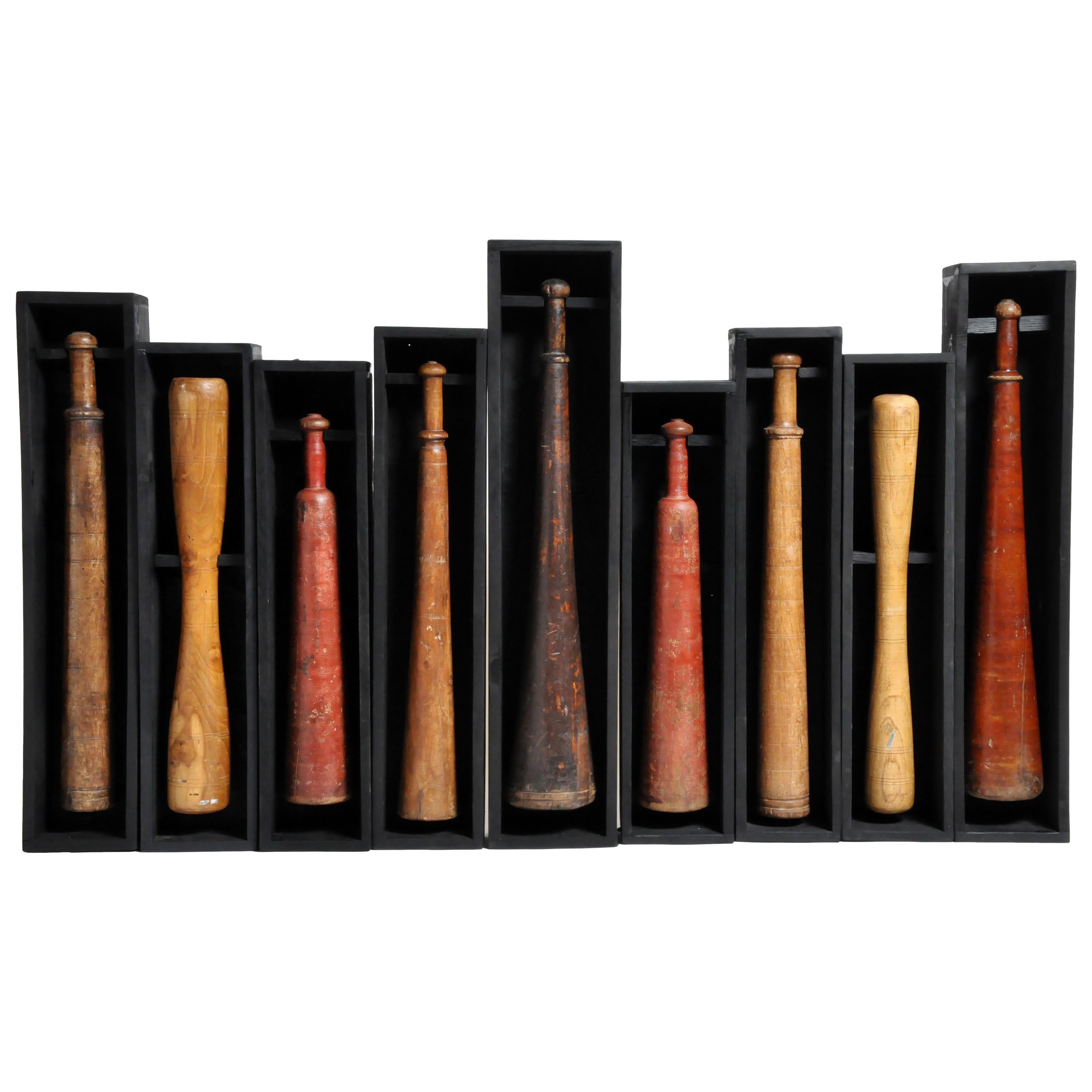 Set of Nine Wooden Exercise Bats Mounted in Wooden Trays