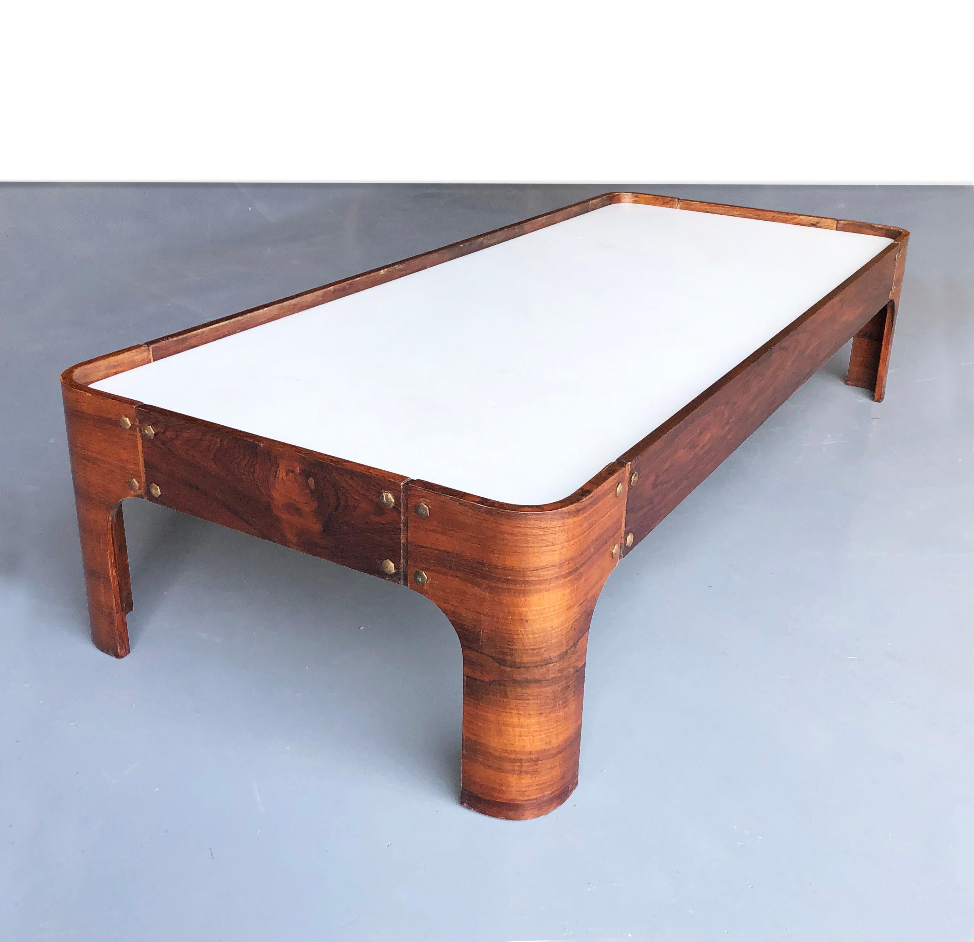 Amazing set of Veneered wood tables by Novo Rumo
Brazil 1960s.
A long coffee table and 2 side tables, in tropical wood finish. 

Beautiful white marble tops. Lovely wood grain and original brass bolts. 
The pictures do not make justice to this set