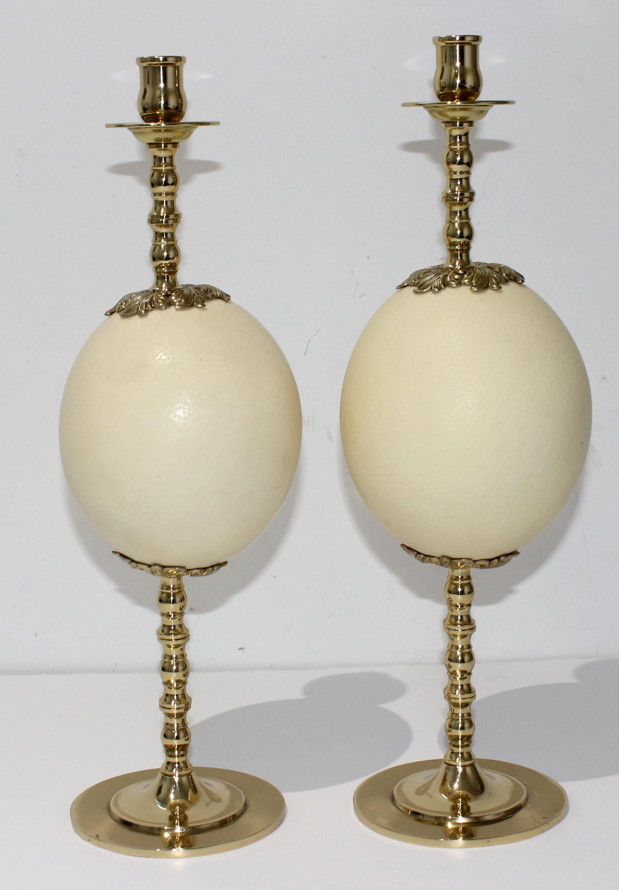 This stylish set of Hollywood Regency ostrich egg candle sticks date the the 1960s and are very much in the style of pieces coveted by Tony Duquette.

Note: The brass has been professionally polished and finished with a clear-coat lacquer, so no