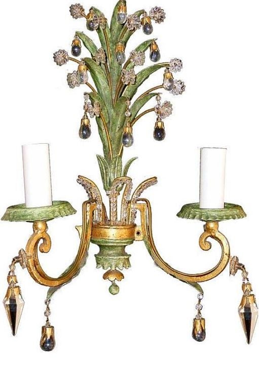 Set of four foliage motif painted and gilt sconces with crystal beads and drops. Sold per pair.

Measurements:
Height 18