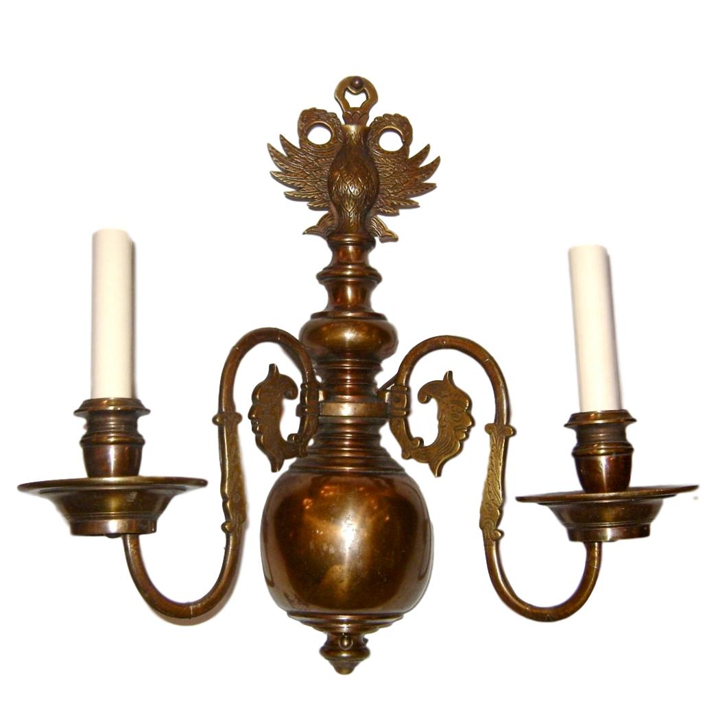 Set of four circa 1920s Dutch patinated bronze sconces with double headed eagles heads crowning the body. Sold in pairs.

Measurements: 
Height 16.5