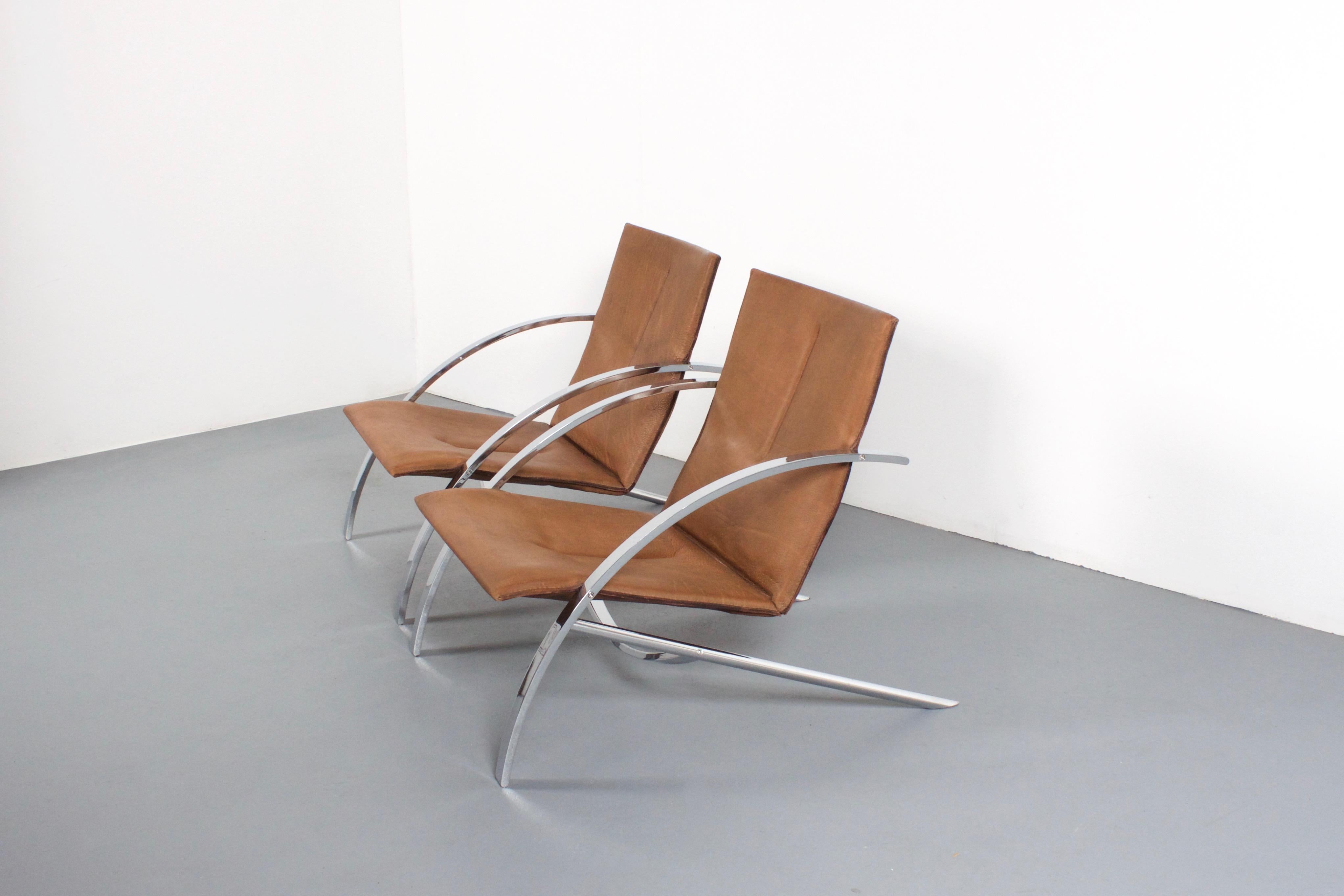 Set of high quality Paul Tuttle ‘Arco’ lounge chairs in very good condition.

Made by Strässle Switzerland.

The chairs have a very heavy polished chrome-plated metal frame. 

The seating of these ‘Arco’ chairs is made from a 4-5 mm. thick natural