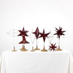 Set of pedagogical models of polygonal shapes in red lacquered zinc with wood