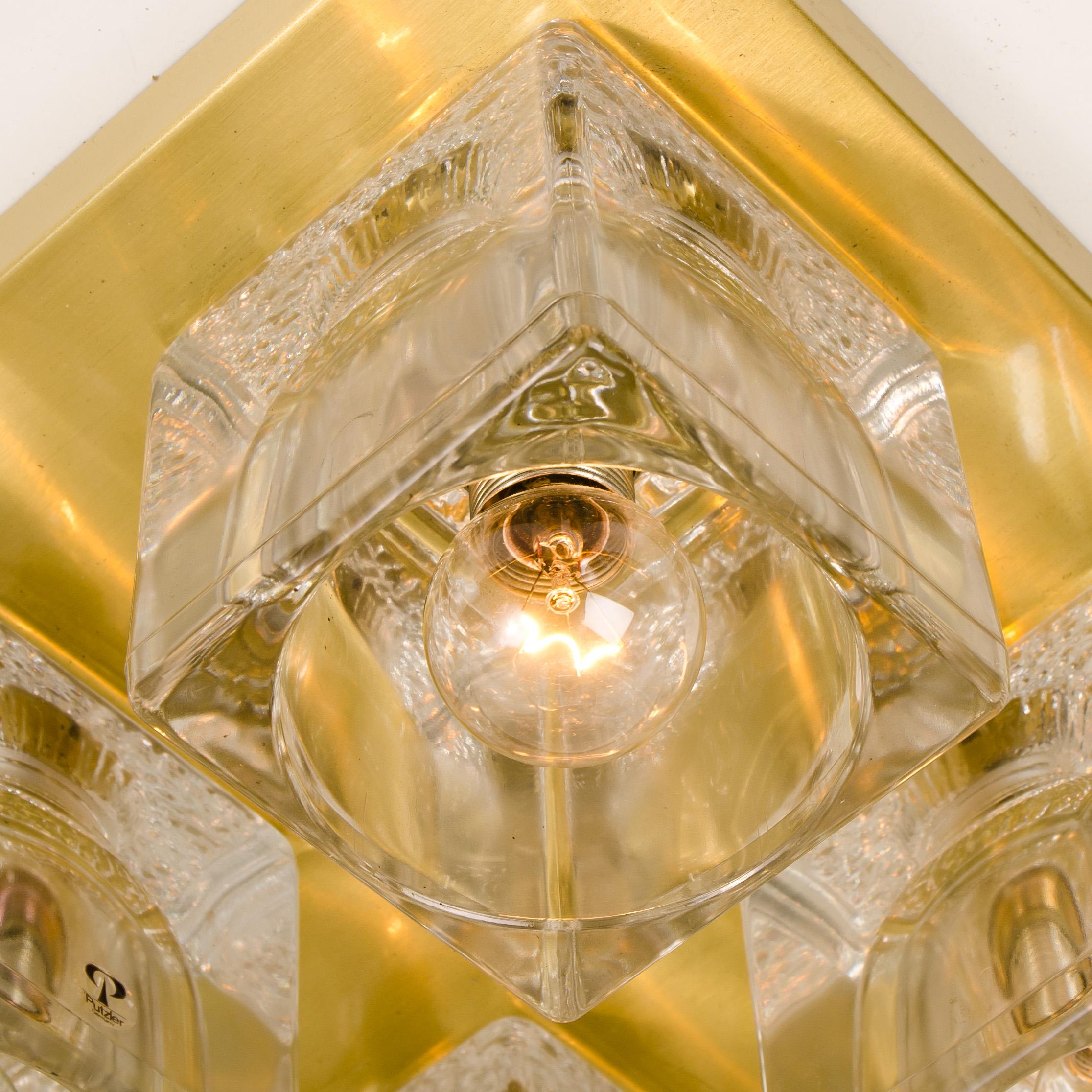 Set of Peill & Putzler wall light ceiling lights, polished brass and glass, 1970s. Each sculptural ceiling light consists of clear glass cubes on a square brass frame which beautifully reflects the light with a warm glow. 

The quality thick clear