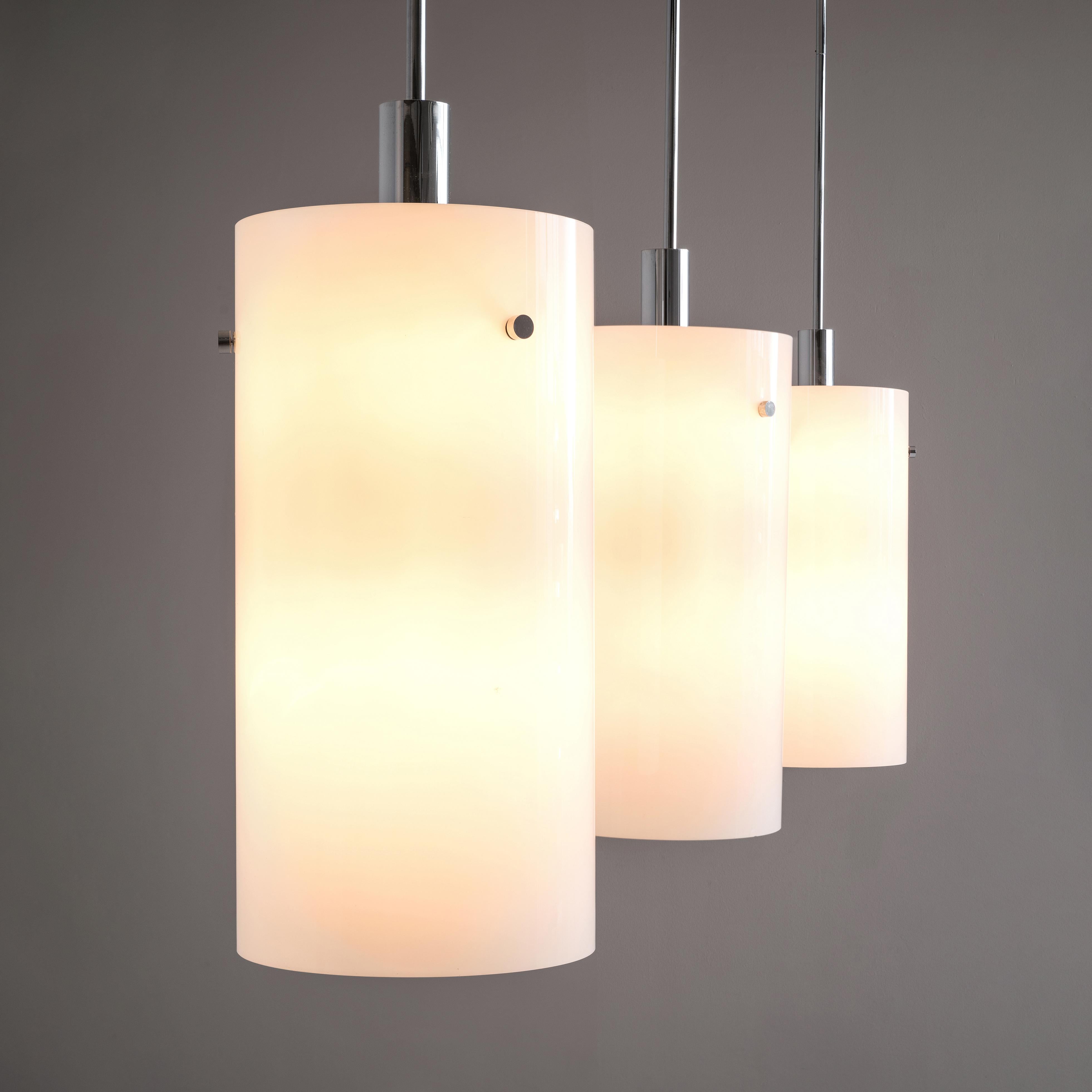Pendants, metal, glass, Europe, 1970s

This large set of atmospheric pendants are cylindrically shaped and executed in white glass, which results in a nice soft light-tone creating a lively ambience in the room. The fixture is based on a minimalist