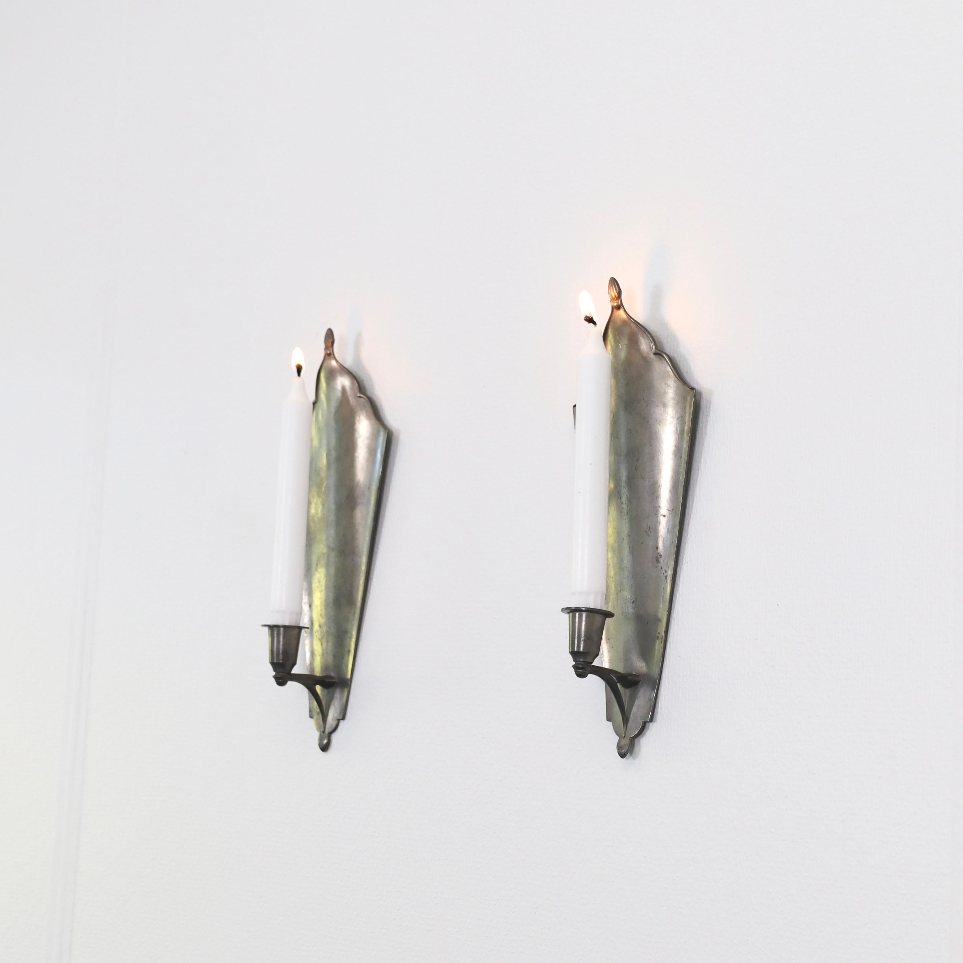 Set of Pewter Wall Candle Sconces designed by Just Andersen in 1920s. A beautiful duo for an exquisite home. 

* Pair (2) of Pewter Wall Candlestick Holders
* Designer: Just Andersen
* Manufacturer: Just Andersen
* Style: 121
* Year: 1918-1926
*
