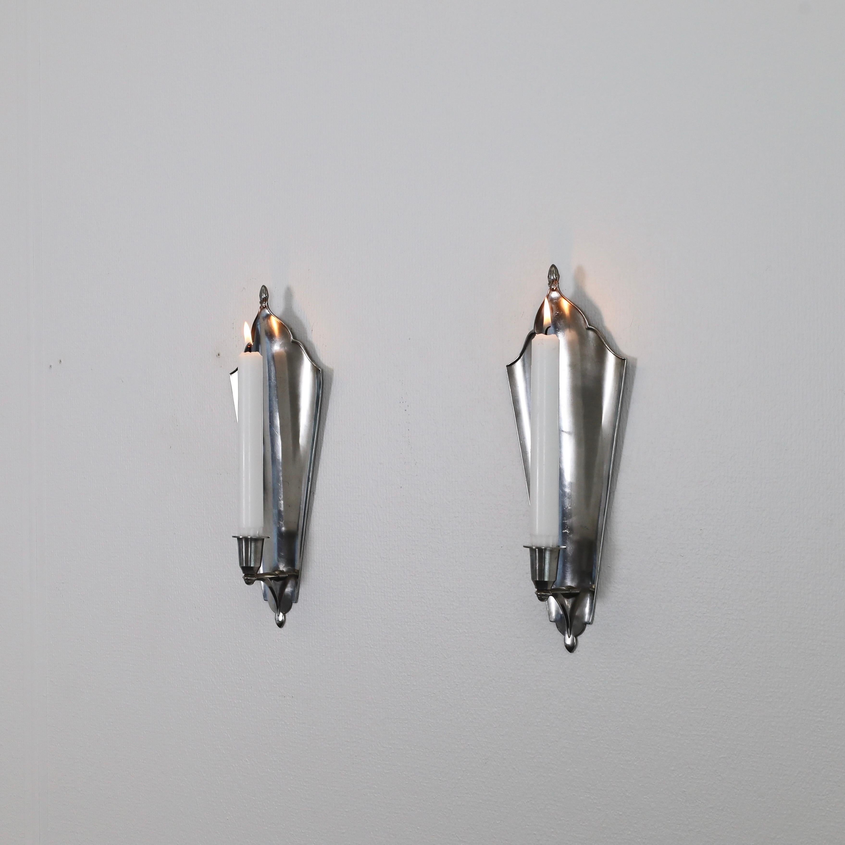 Set of Pewter Wall Candle Sconces designed by Just Andersen in 1920s. A exquisite duo for beautiful place. 

* Pair (2) of Pewter Wall Candlestick Holders
* Designer: Just Andersen
* Manufacturer: Just Andersen
* Style: 121
* Year: 1918-1926
*