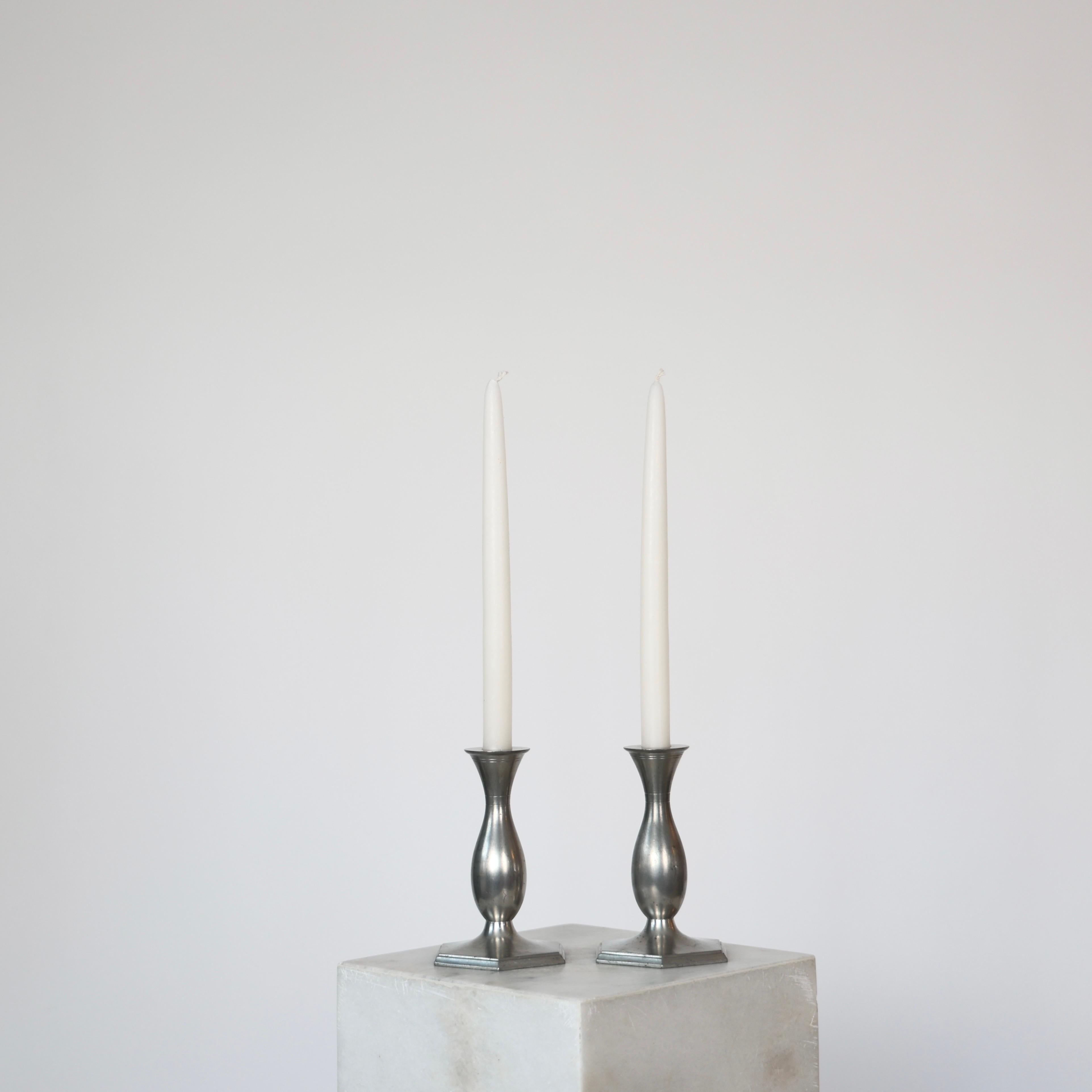 Set of Art Deco Pewter Candlestick designed by Just Andersen in 1920s. 

* Set (2) of pewter candlestick holders on hexagon foot.
* Designer: Just Andersen
* Manufacturer: Just Andersen
* Style: 1165
* Year: 1918-1926
* Condition: Good vintage