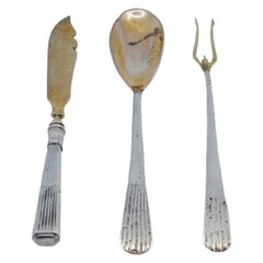 Set of pickle fork, butter knife and sauce spoon in gold with fluted handles