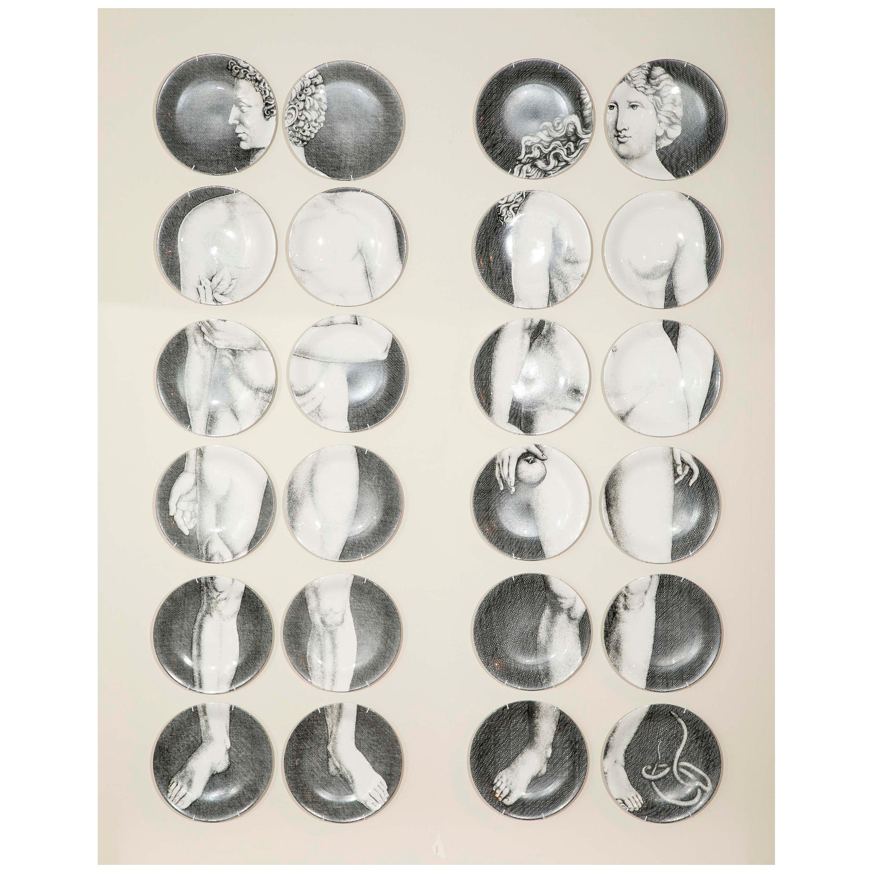 A beautiful set of 24 Pierro Fornasetti plates depicting full body images of Adam and Eve on Transfer-printed porcelain. Each plate is signed, titled and numbered: 