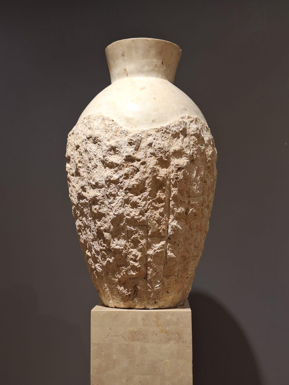 Unique set of pillar and vase.

Made from Travertine.

The vase has a rough, organic part as well as a polished upper part.
The pillar is square shaped and has a rough lower strip, which matches the organic part of the vase.

Vase dimensions

H x
