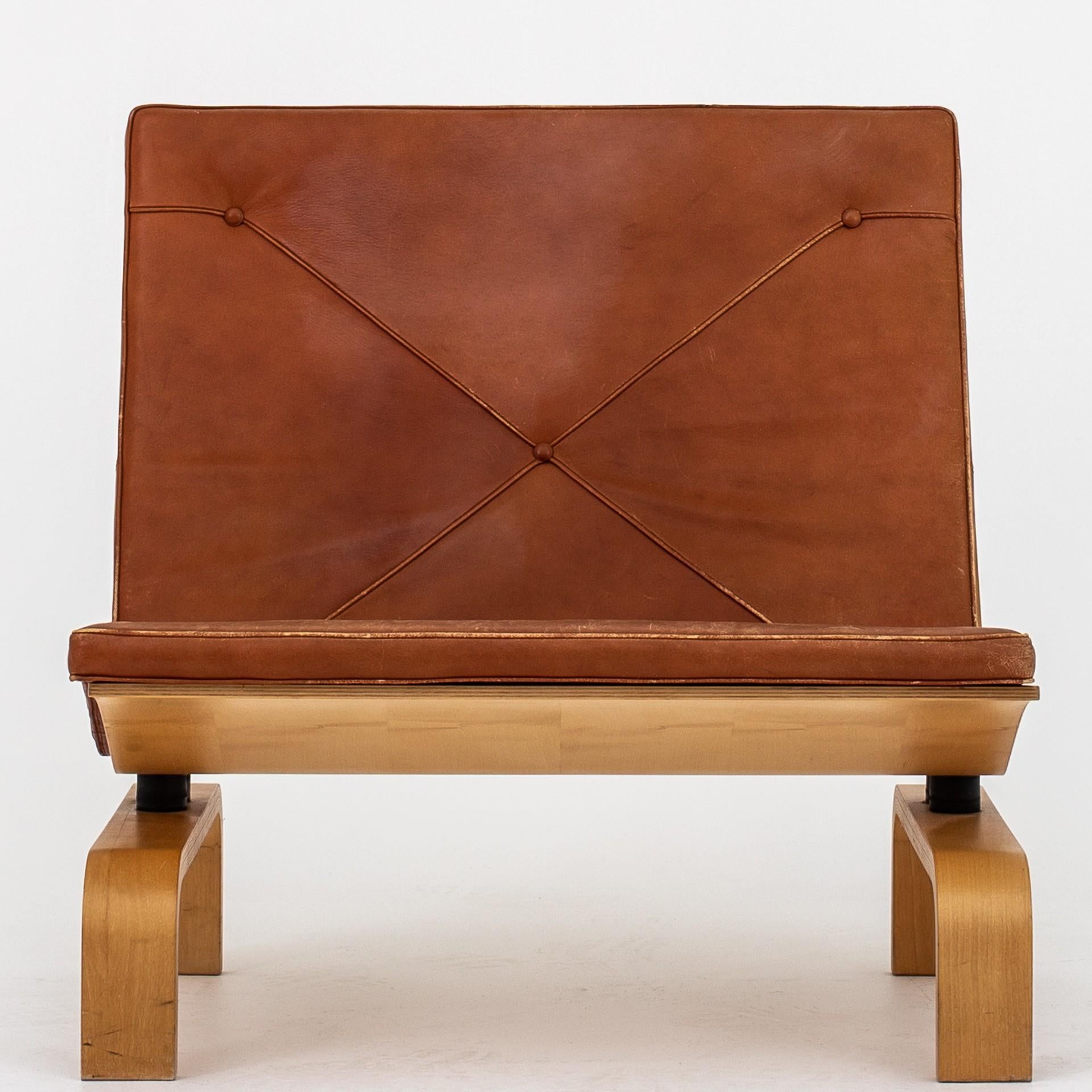 PK 27 - Set of 2 easy chairs and 1 coffee table w. special measurements. The set is made in maple and w. original, patinated cognac leather. Designed in 1971. Table 60 x 60 Height 25 cm. Maker E. Kold Christensen.