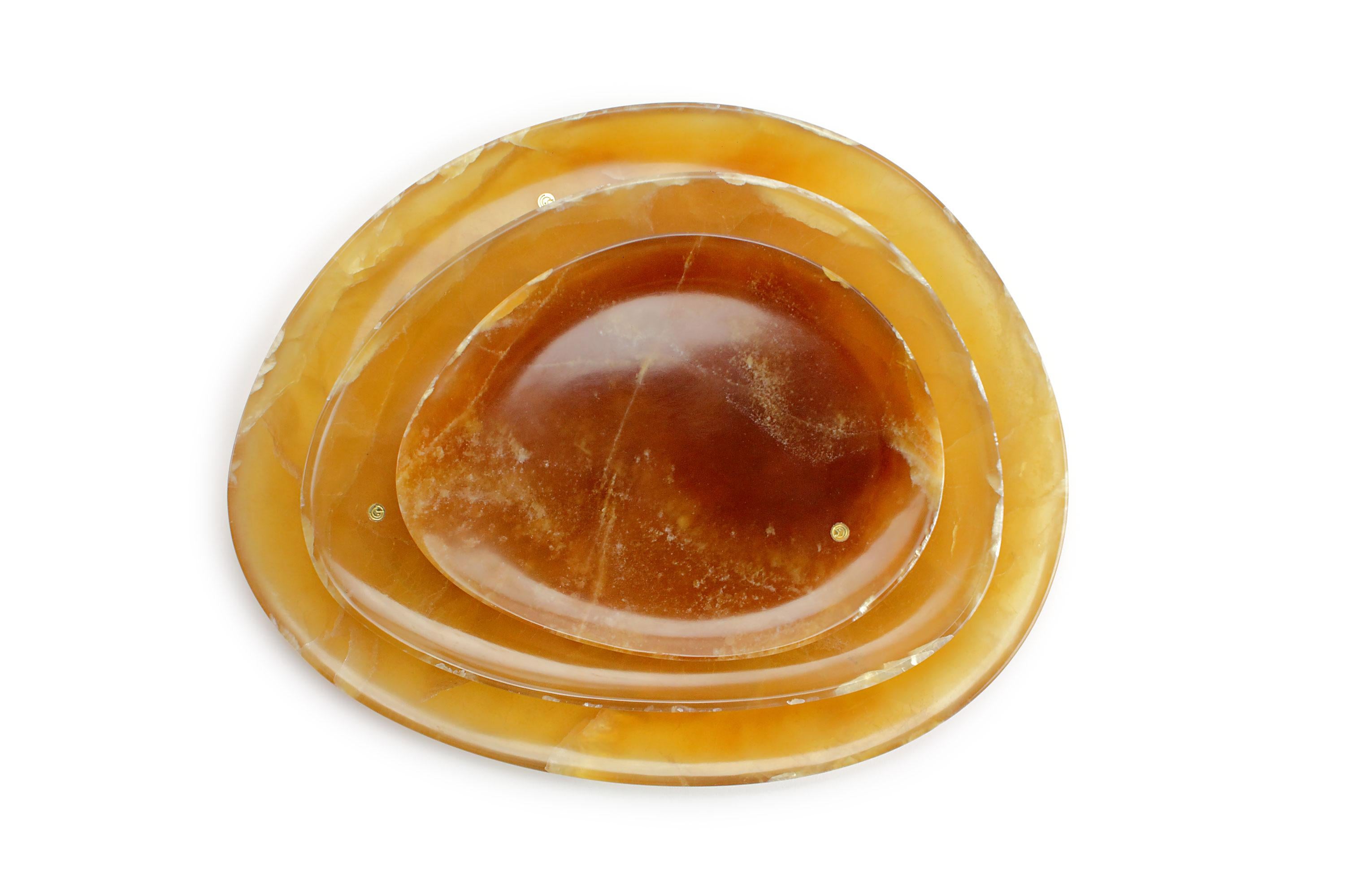 Hand carved presentation plates in Amber Onyx. Multiple use as plates, platters and placers. 

Dimensions: Small - L 24 W 20 H 1.8 cm, Medium - L 30 W 28 H 1.8 cm and Big - L 36 W 35 H 1.8 cm.
Available in different marbles, onyx and quartzite.