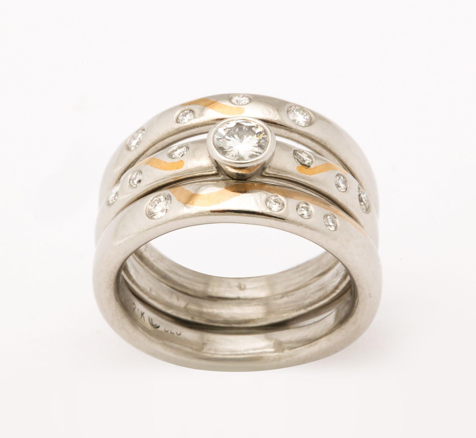Three interesting stacking rings each with diamonds interspersed and one with a single diamond.
They are sold as a set and can be sized to fit.