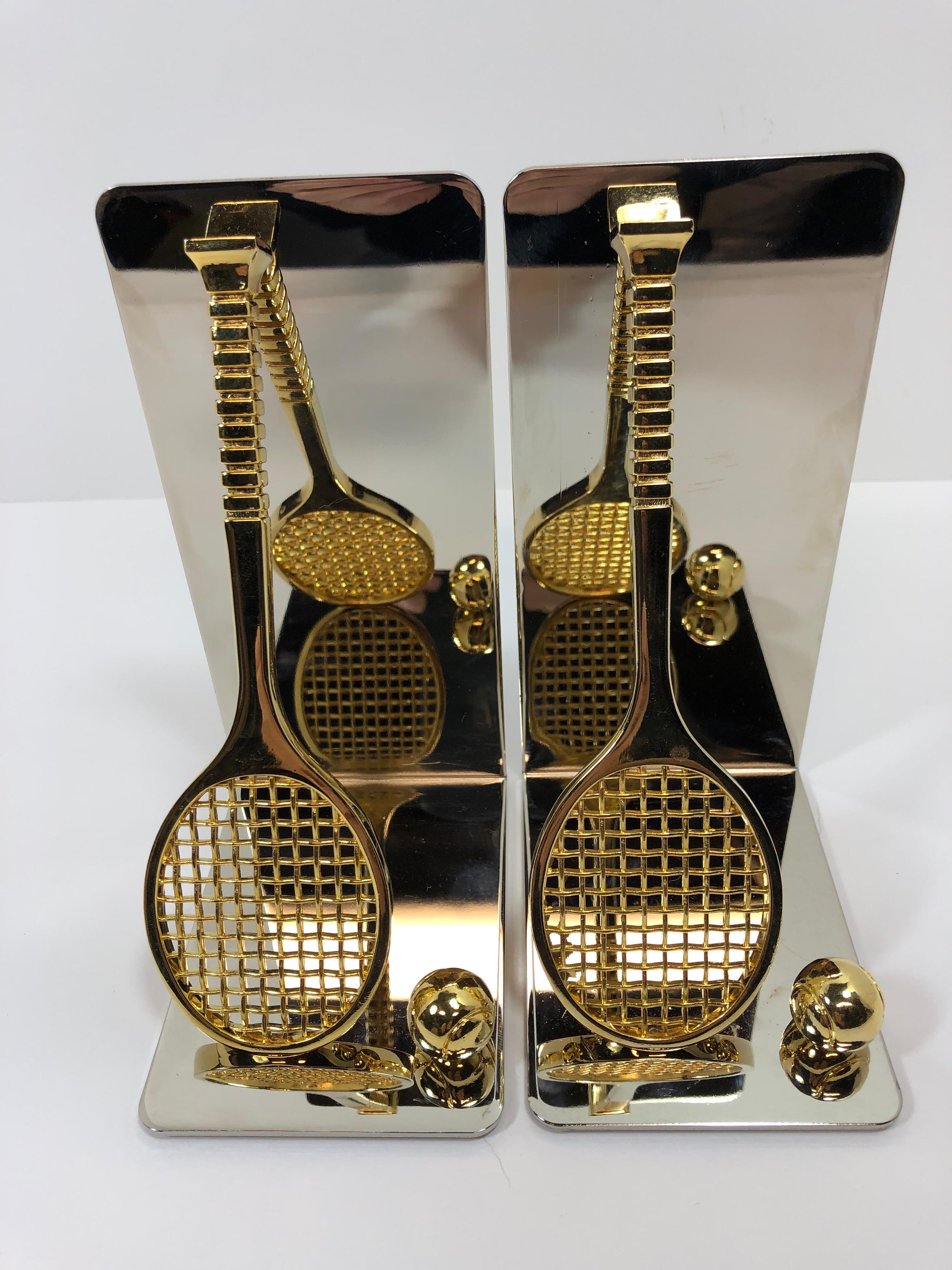 Set of brass and chrome tennis racket bookends. Has thin foam on bottom to prevent scratching furniture.
