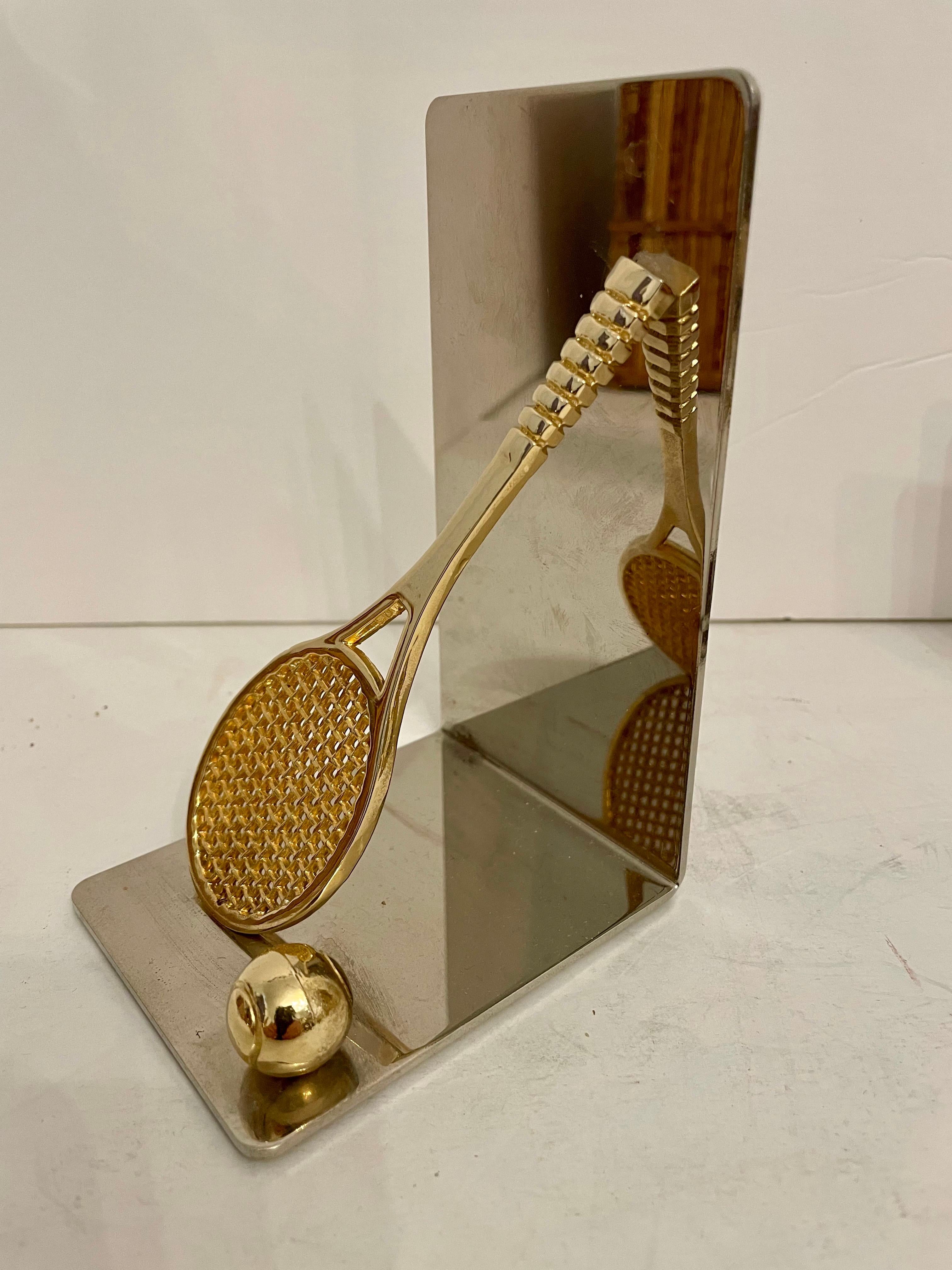 Set of brass and chrome tennis racket bookends. Has thin foam on bottom to prevent scratching furniture. 5.5