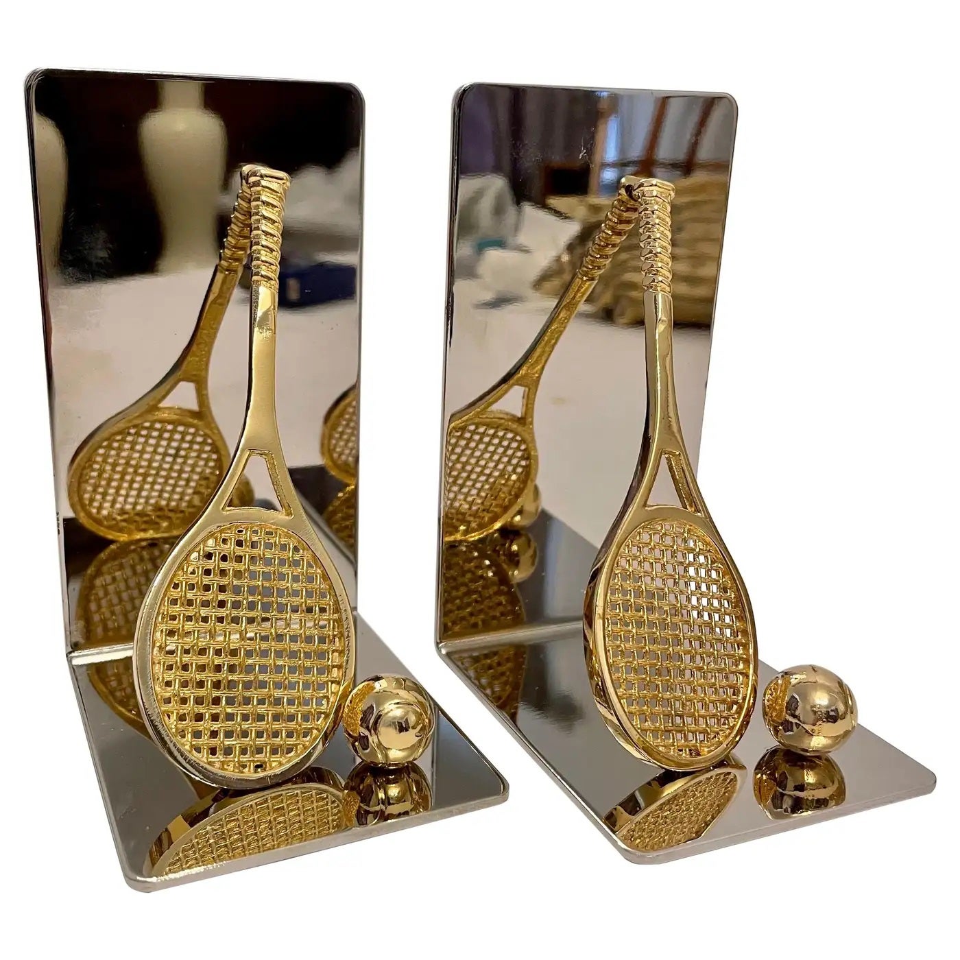 Set of brass and chrome tennis racket bookends. Has thin foam on bottom to prevent scratching furniture. 5.5