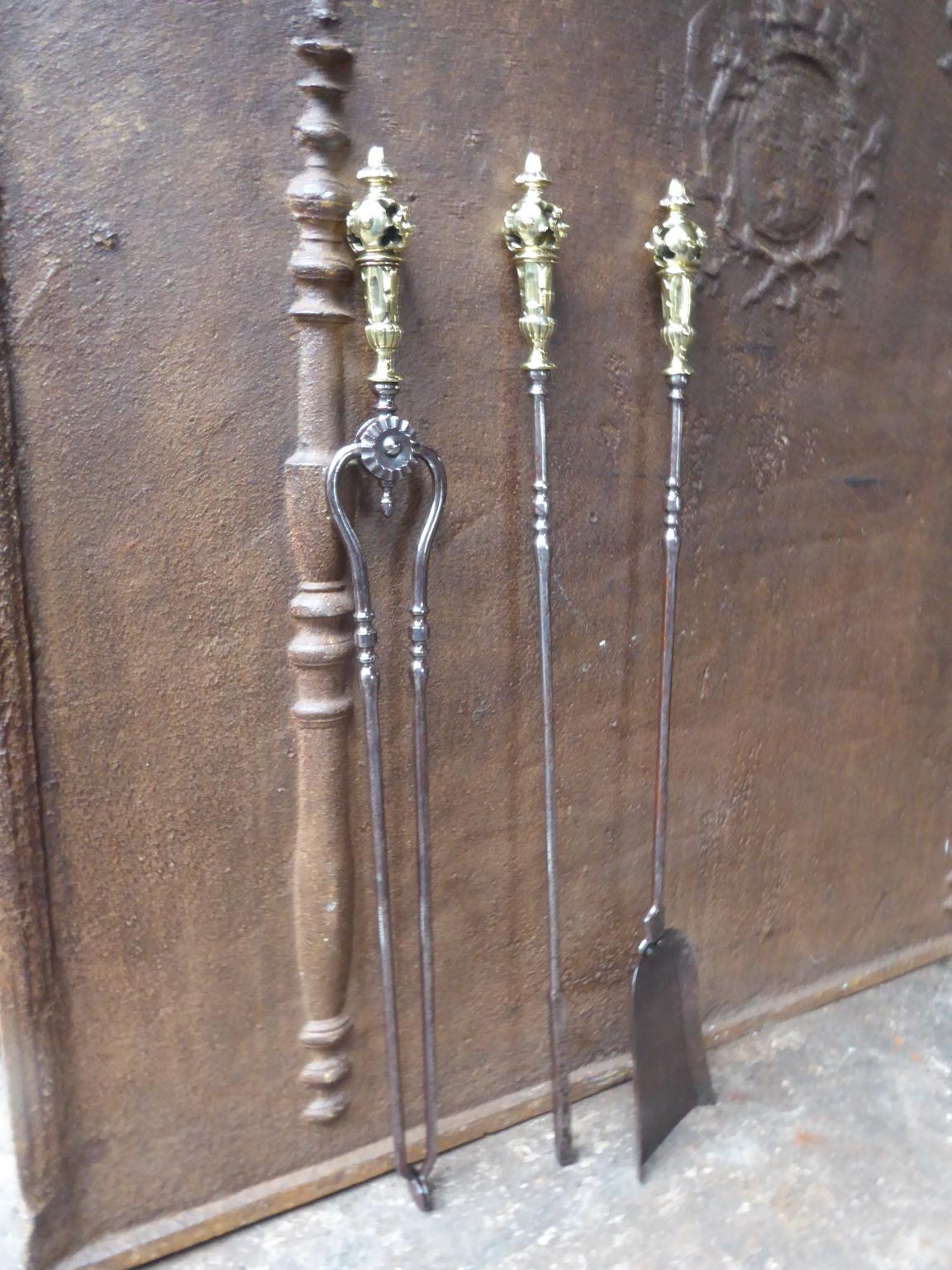 Elegant English set of three polished steel fireplace tools each with ring banded shafts
and with rare impressive polished brass handles. The fire tool set is in a good condition and is fully functional, 19th century, Victorian.

We have a unique