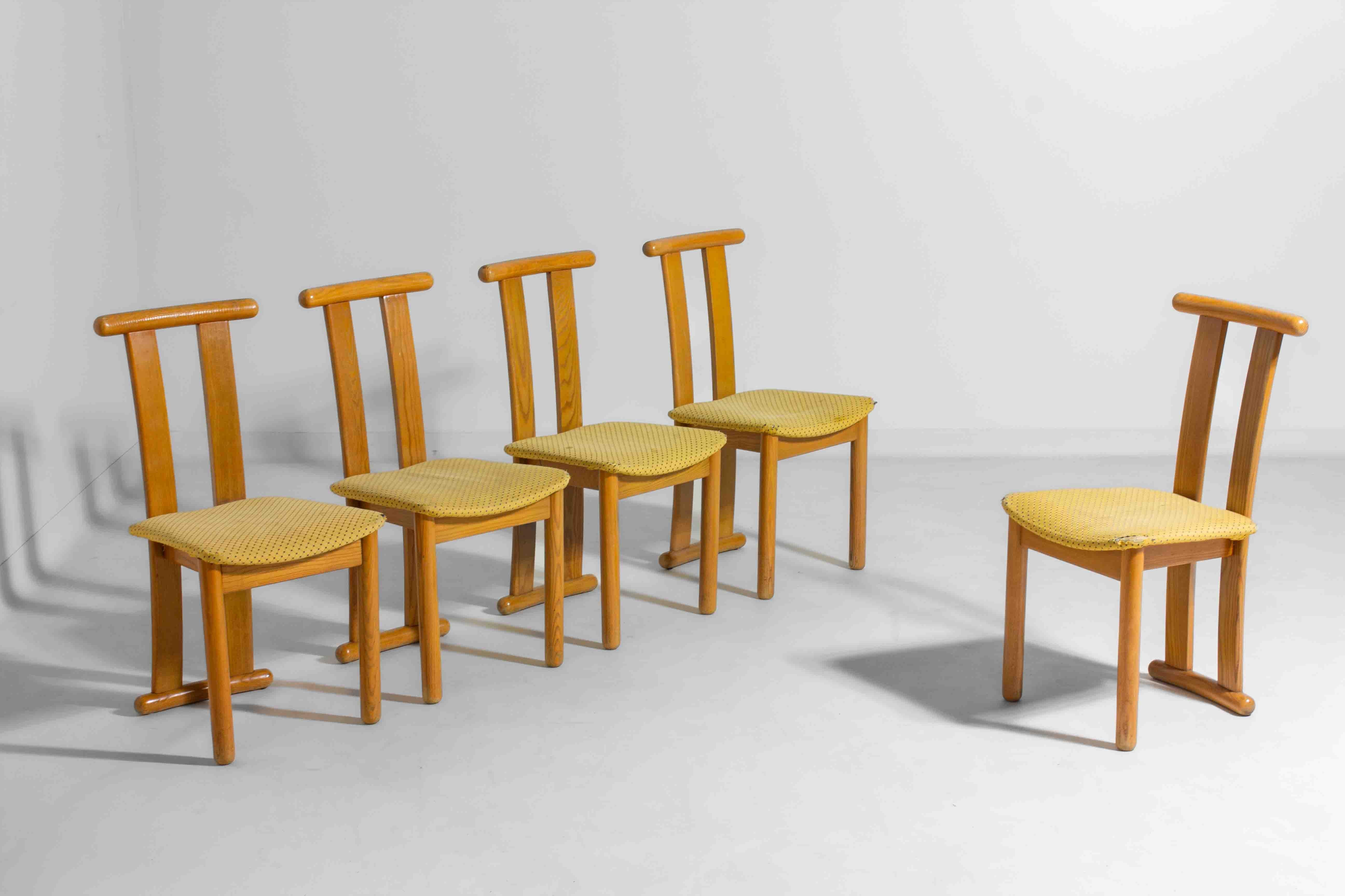 This rare set of five Italian high-back dining chairs from the 1980s is crafted from solid beech wood. The simple, clean lines are paired with rounded edges, giving them a soft and approachable look. The bright yellow upholstered seats add a playful