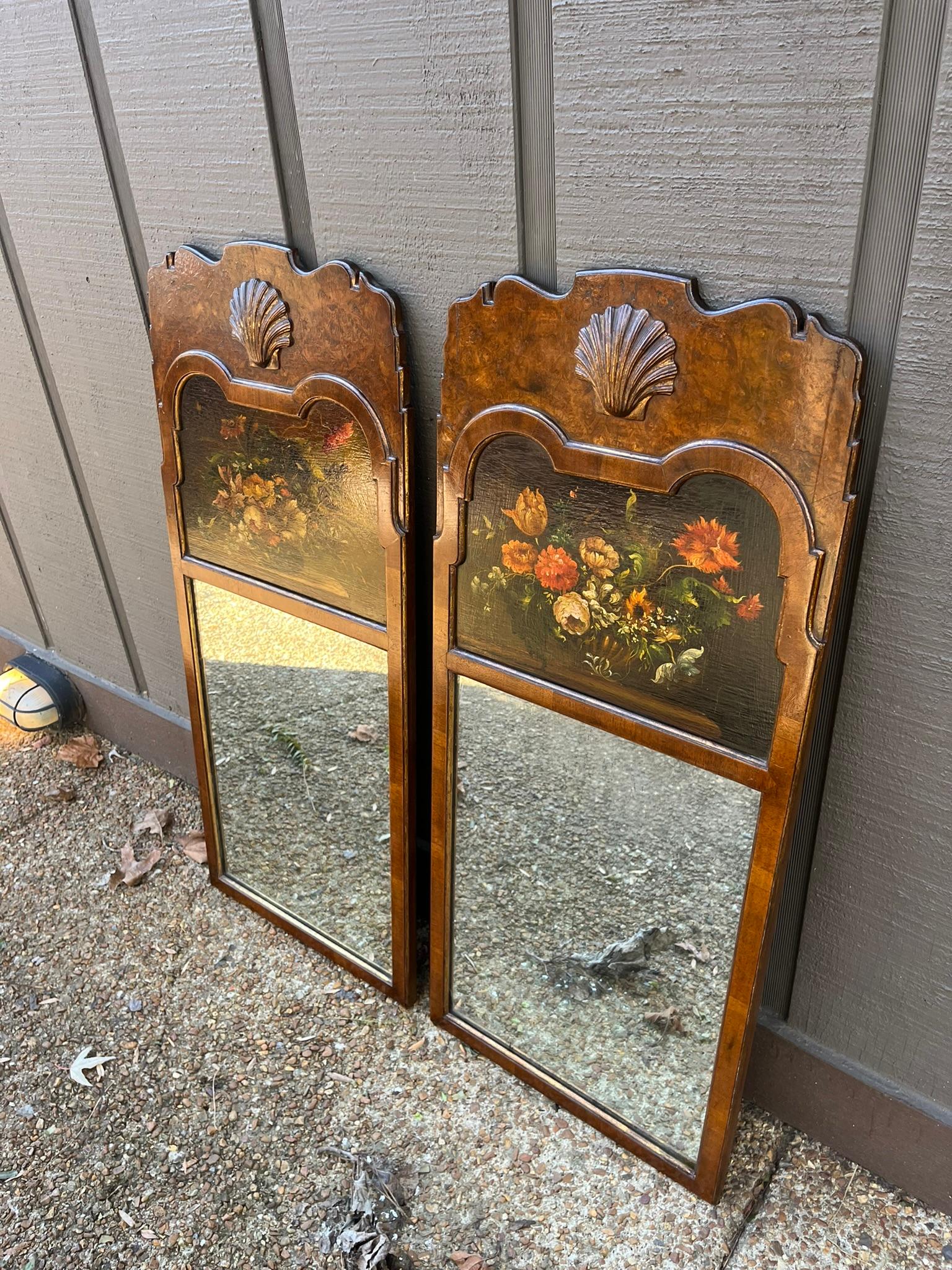 Walnut and burl walnut with gilt highlights looking glasses. The scalloped crest with a carved centralized shell. Each with a floral painted on board , inset above lightly distressed mirror plates.
A hard to find pair or set in the style of the 18th