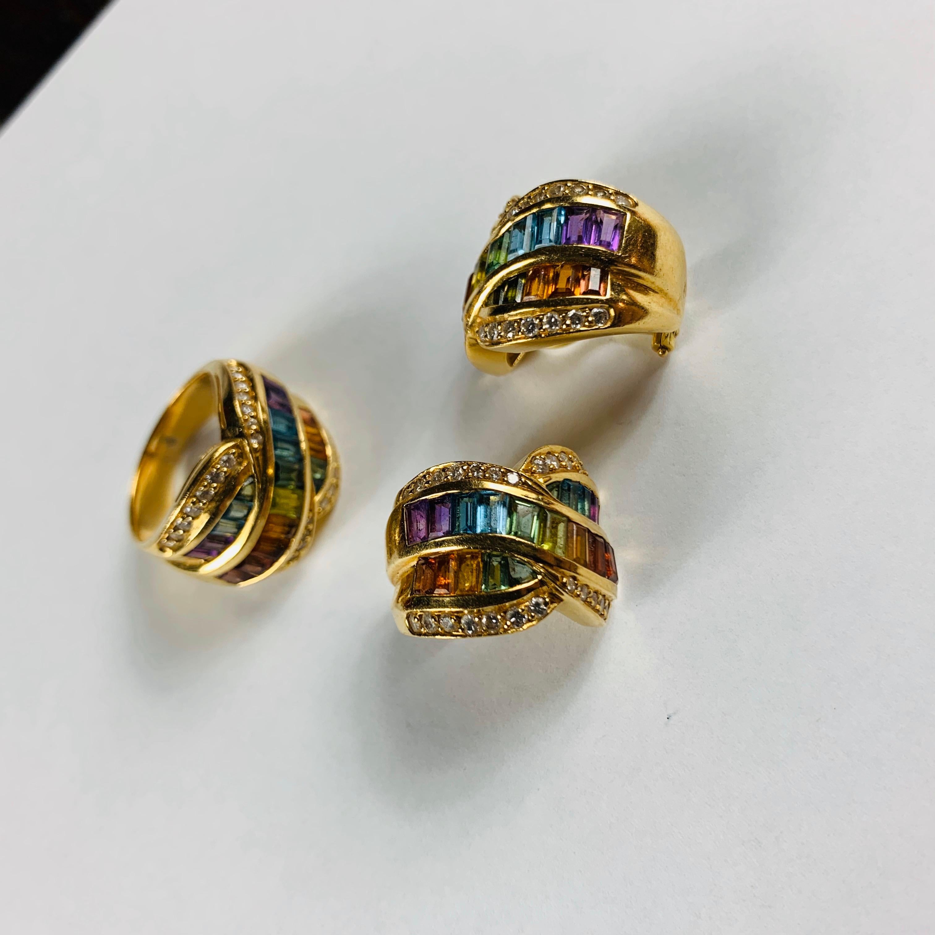 A Beautiful Contemporary Bow Shaped 18 Carrat Earrings And Dome Rings, Consisting of Rainbow Green, Red, Yellow, Pink, Purple And Blue Sapphires With Pave Diamond Edging Detail.