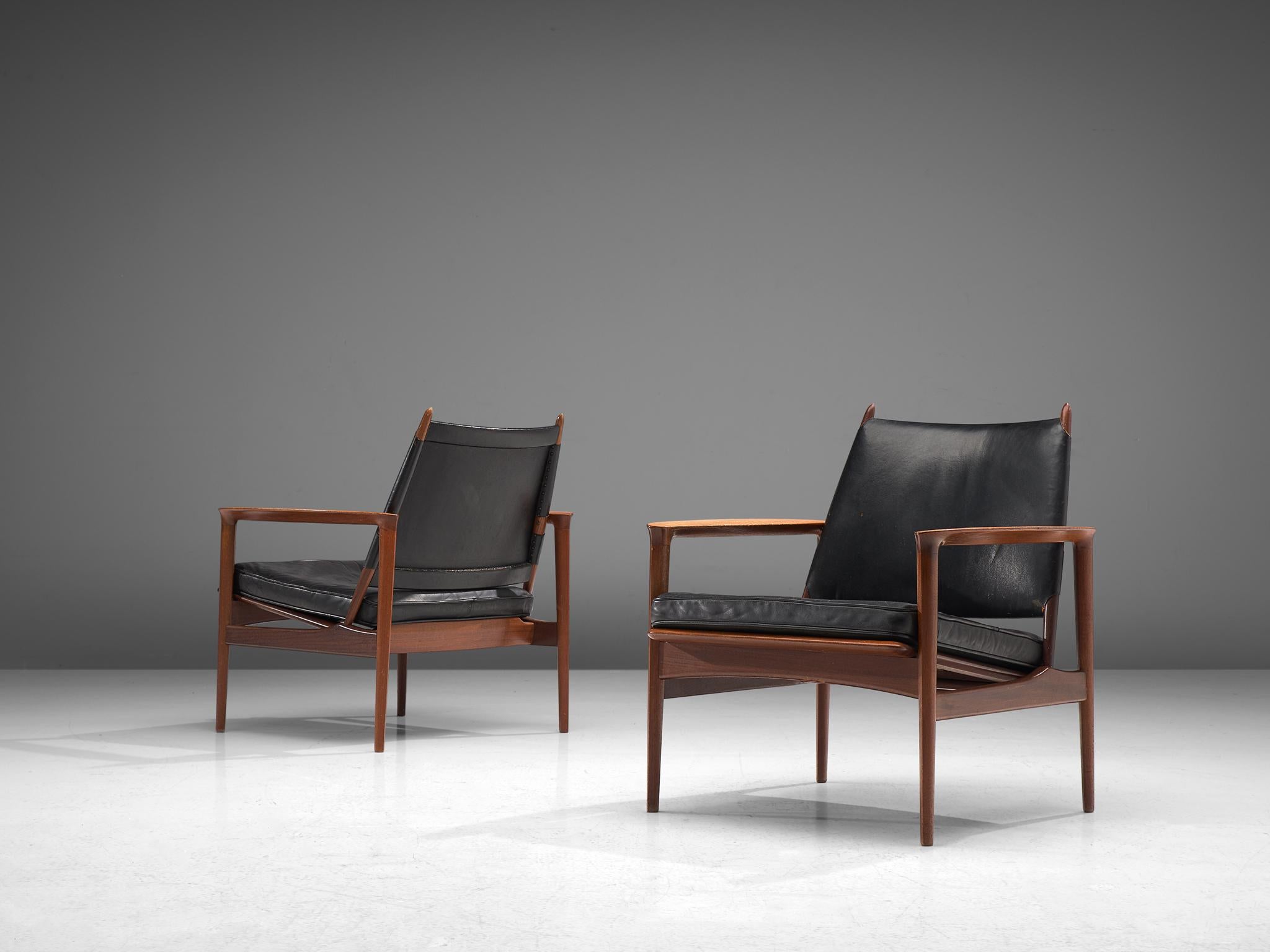Torbjørn Afdal pair of armchairs in teak and black leather, Norway, 1960s.

These rare armchairs by Torbjørn Afdal show outstanding craftsmanship. The woodwork is elegant, showing nice details and wood joints. Due to the openness of the frame, the