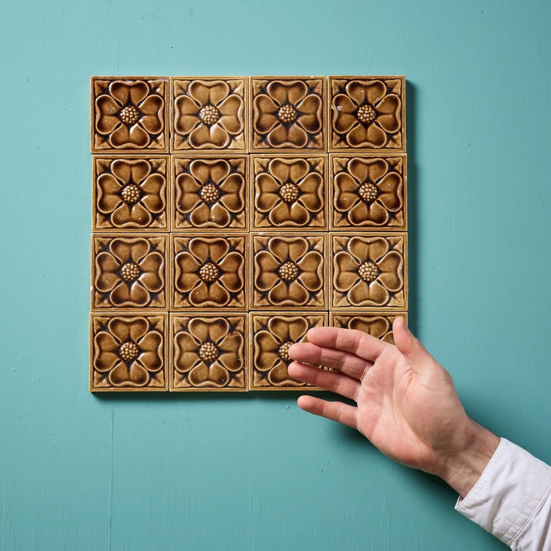 Group of 21 reclaimed glazed tiles by the makers Carter Tiles displaying ochre and buff stylised Tudor roses.



These 3-inch tiles could be used in several ways including a decorative panel or a vibrant splashback for a vintage kitchen.



Supplied