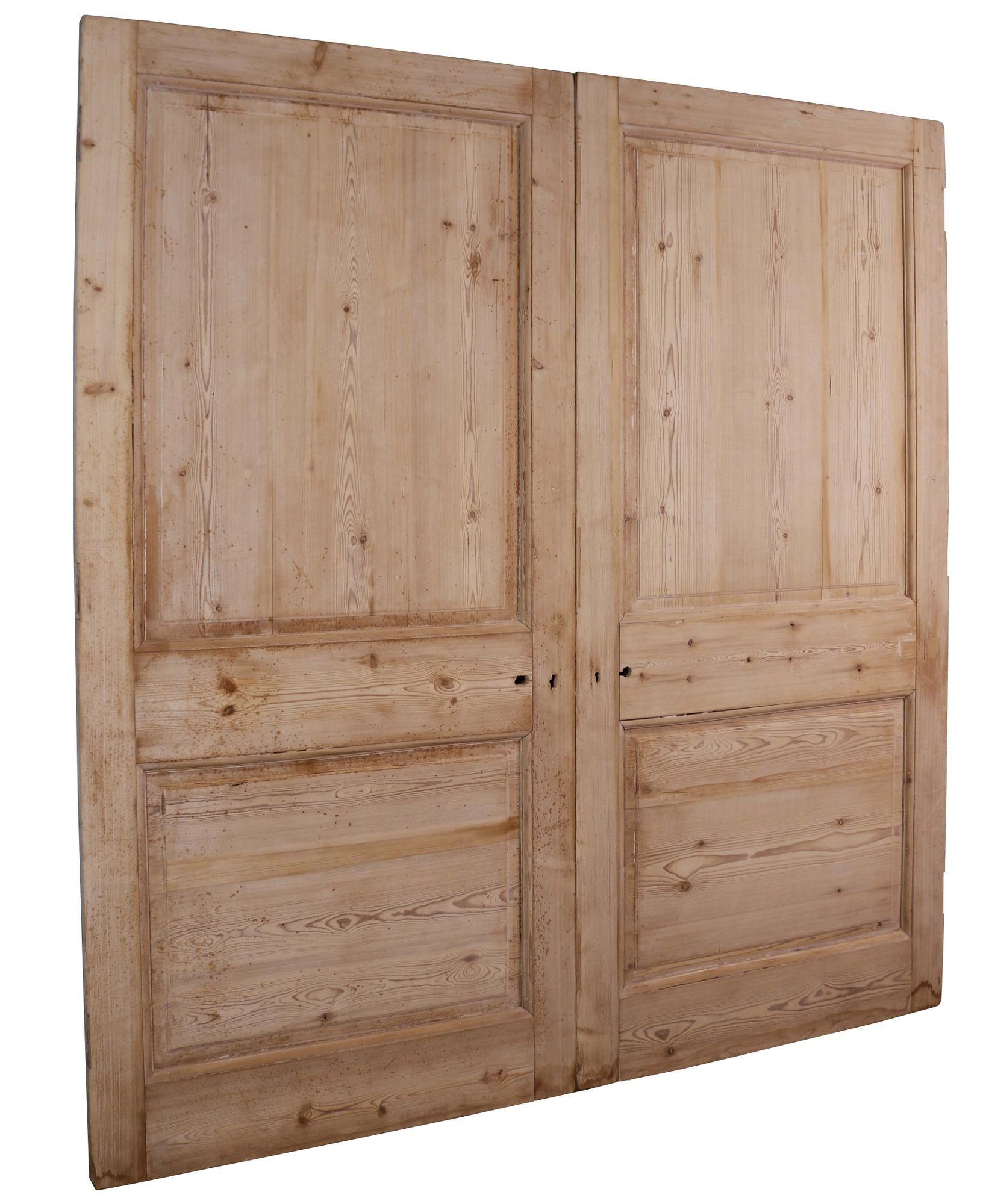 Set of reclaimed pine dividing doors. A set of antique double doors made from pine, with raised and fielded panels.