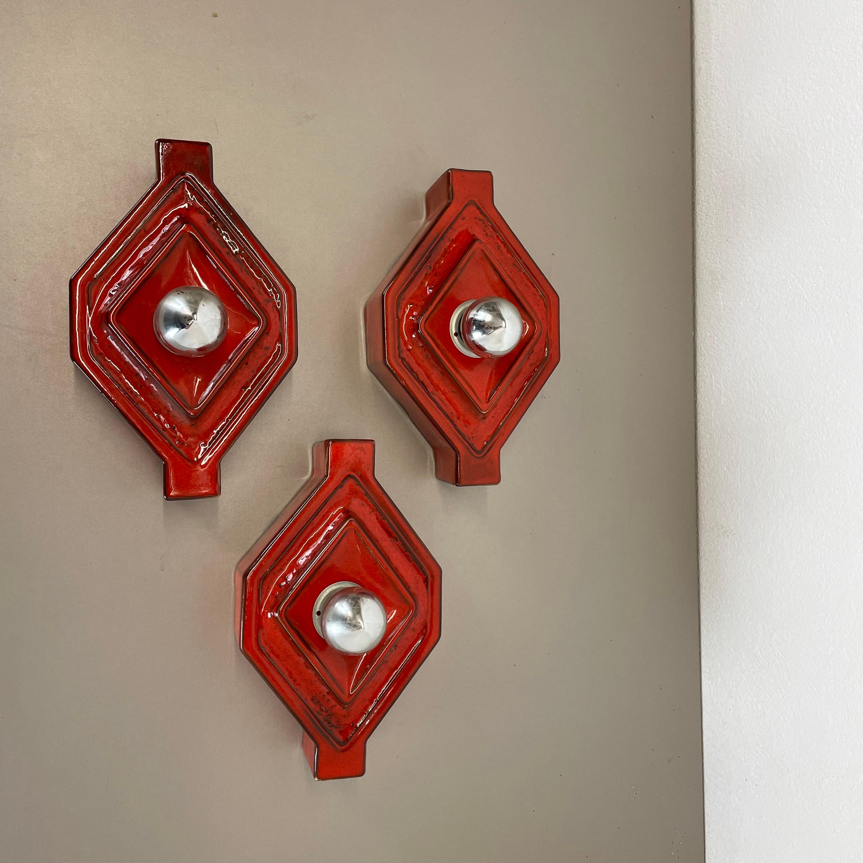 Article:

Wall light sconce set of three


Producer:

Pan Ceramic, Germany.



Origin:

Germany.



Age:

1970s.



Description:

Original 1970s modernist German wall lights made of ceramic in fat lava optic. This super rare set of three walls light