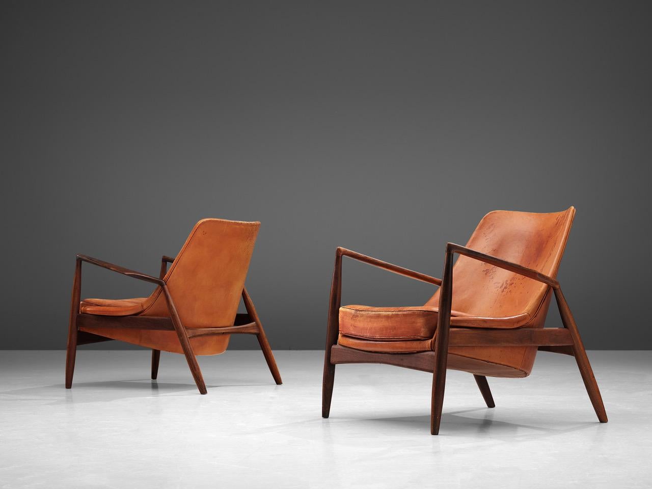 Set of Ib Kofod-Larsen for OPE, 'Sälen' (Seal) lounge chairs model 503-799, teak and leather, Sweden, 1956. 

Iconic pair of 'Seal' lounge chairs by Ib Kofod-Larsen. The well-crafted frame of these chairs are made of teak. It shows very nice