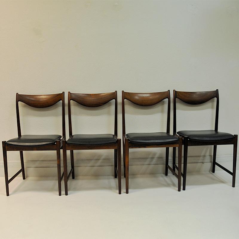 Set of four beautiful midcentury dining chairs model ’Darby’ in solid rosewood and black leather seats. These chairs are designed by Torbjørn Afdal for Bruksbo and manufactured in Norway by Nesjestranda  møbelfabrikk in the early 1960s. Label