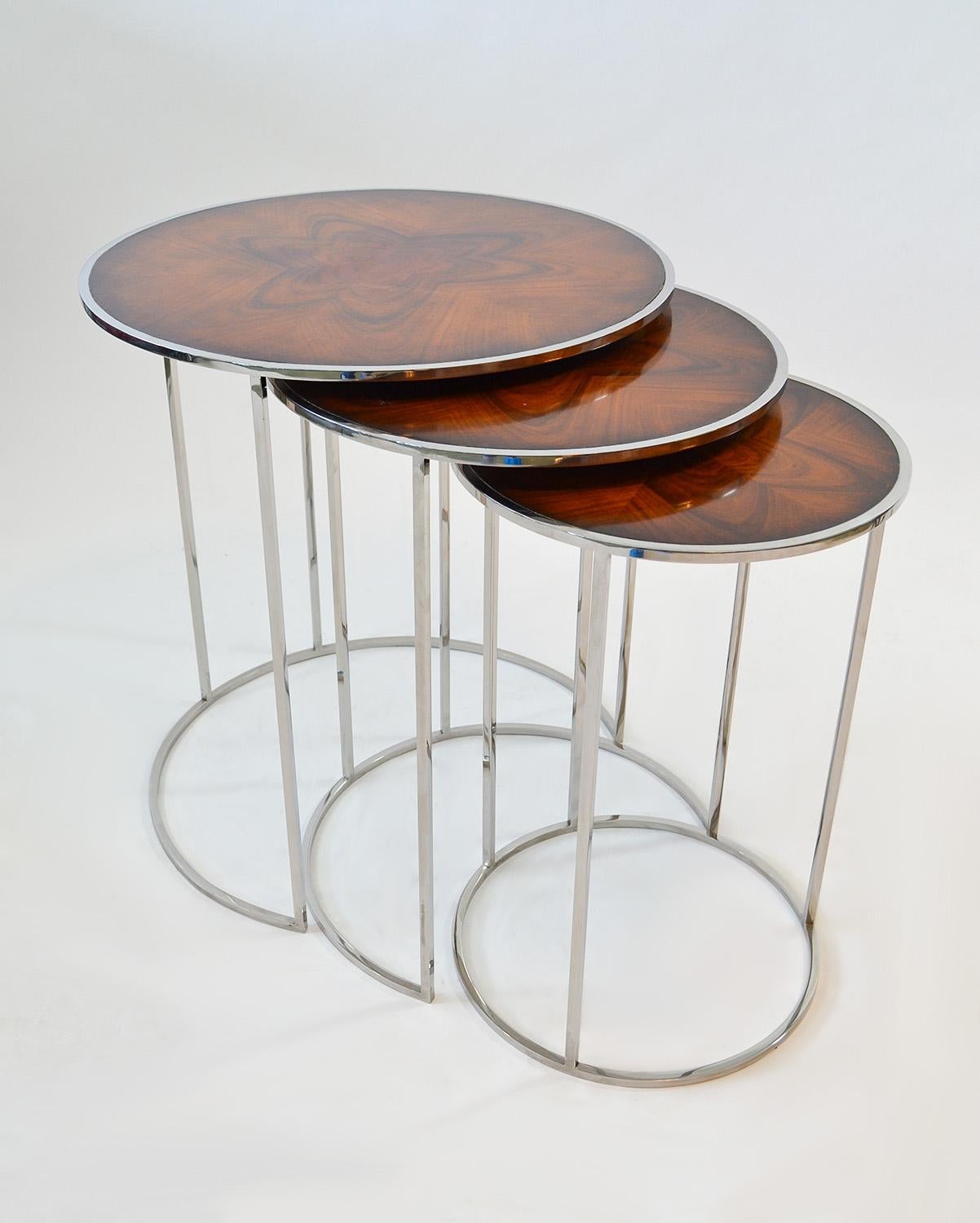 Set of Round Nesting or Stacking Tables in Exotic Burlwood and Chrome
Circular design nesting tables in gloss finish exotic burlwood veneer over heavy chromed steel bases. Diameters largest to smallest measure 22