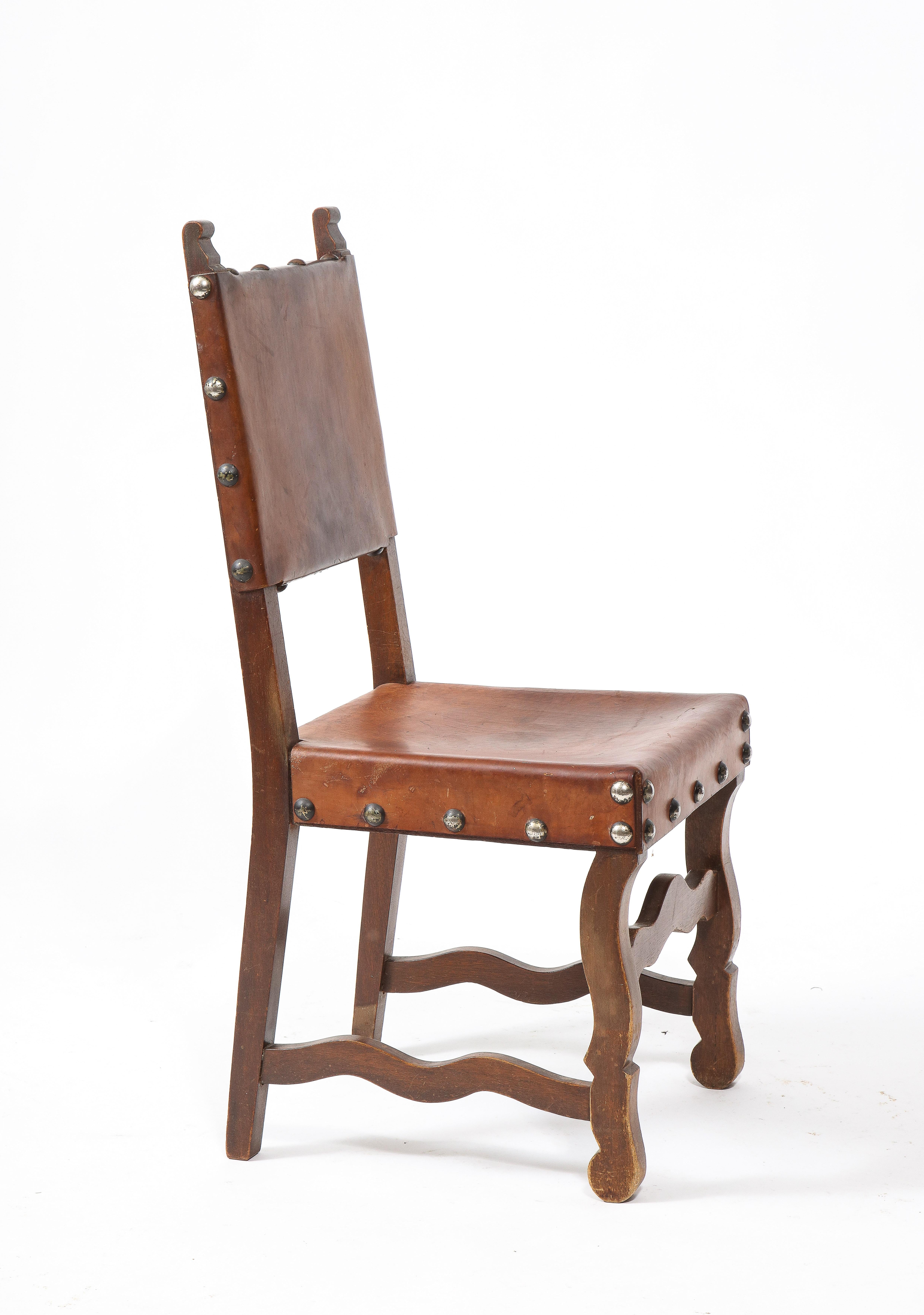 A set of rustic Spanish chairs with leather slings, classic structure in the 