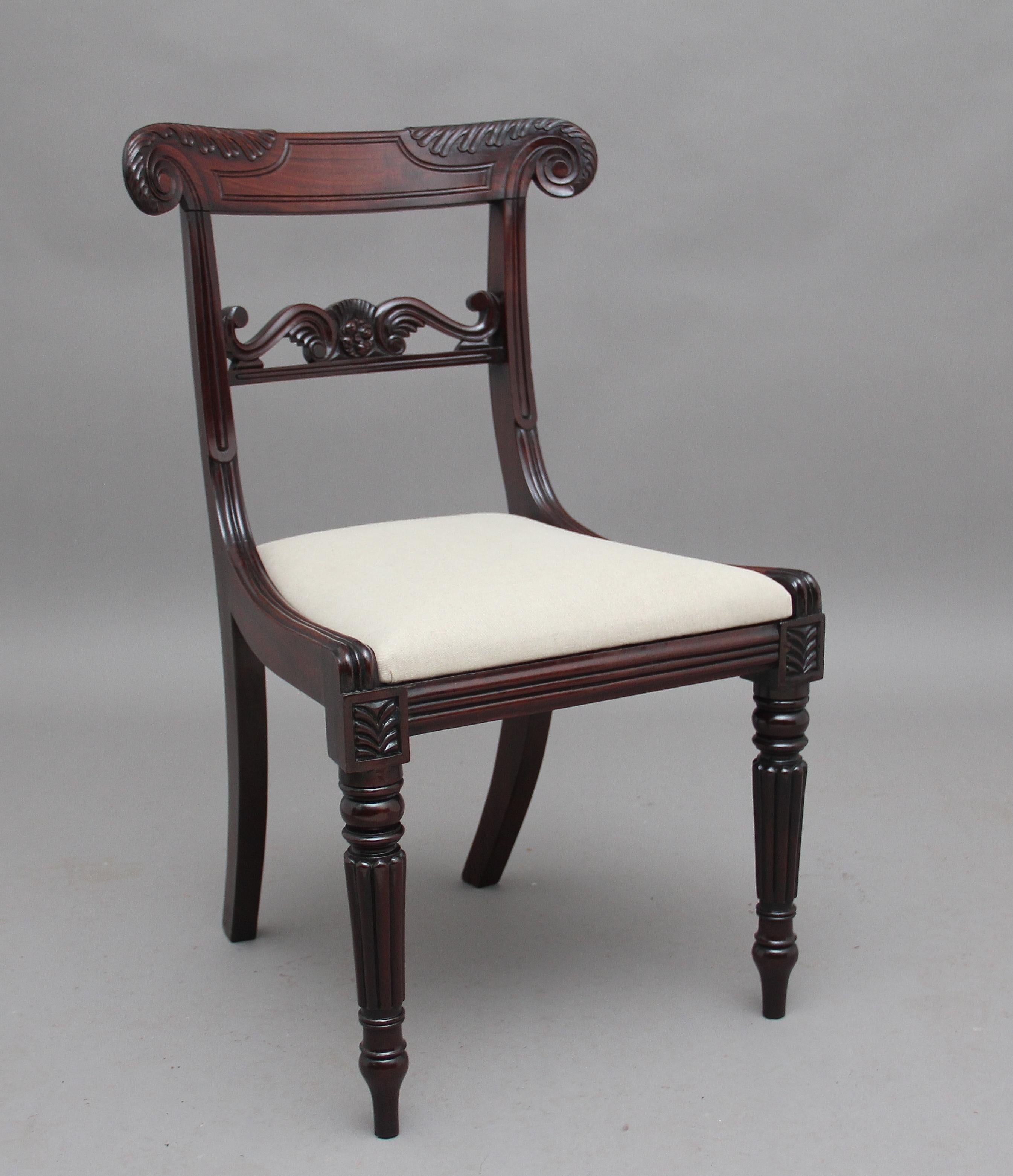 A set of seven early 19th century mahogany dining chairs, each having acanthus leaf carved rails, re-upholstered drop in seat, supported on swept rear legs and ring turned and reeded tapering front legs, circa 1830.