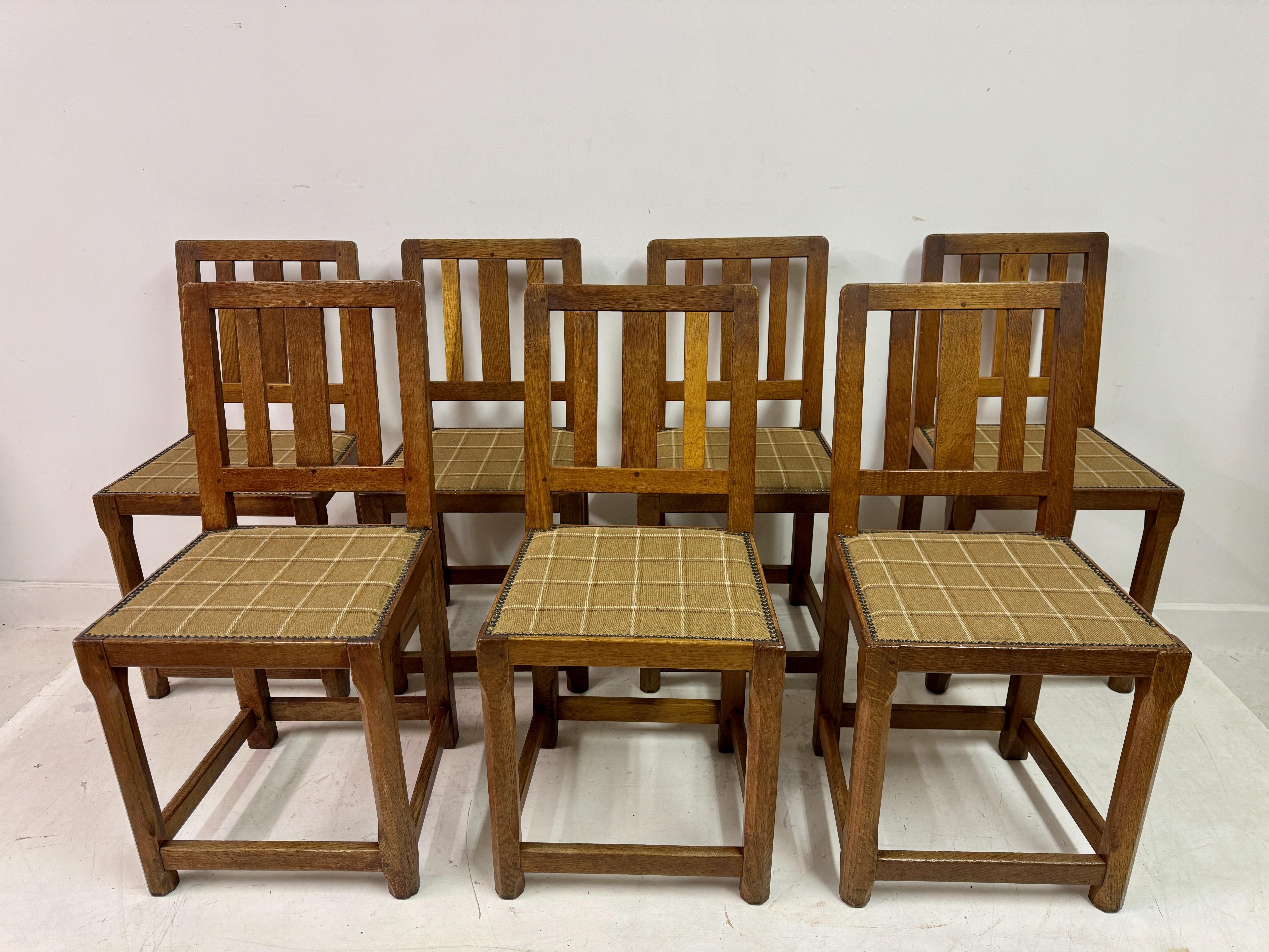 Set of seven Arts and Crafts dining chairs

A set of seven oak dining chairs embodying the honest craftsmanship and timeless aesthetic of the Arts and Crafts movement. Crafted from solid oak, these chairs showcase a beautifully simple yet