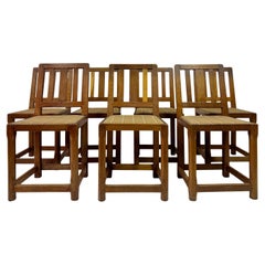 Juego de siete sillas de comedor Arts and Crafts de roble