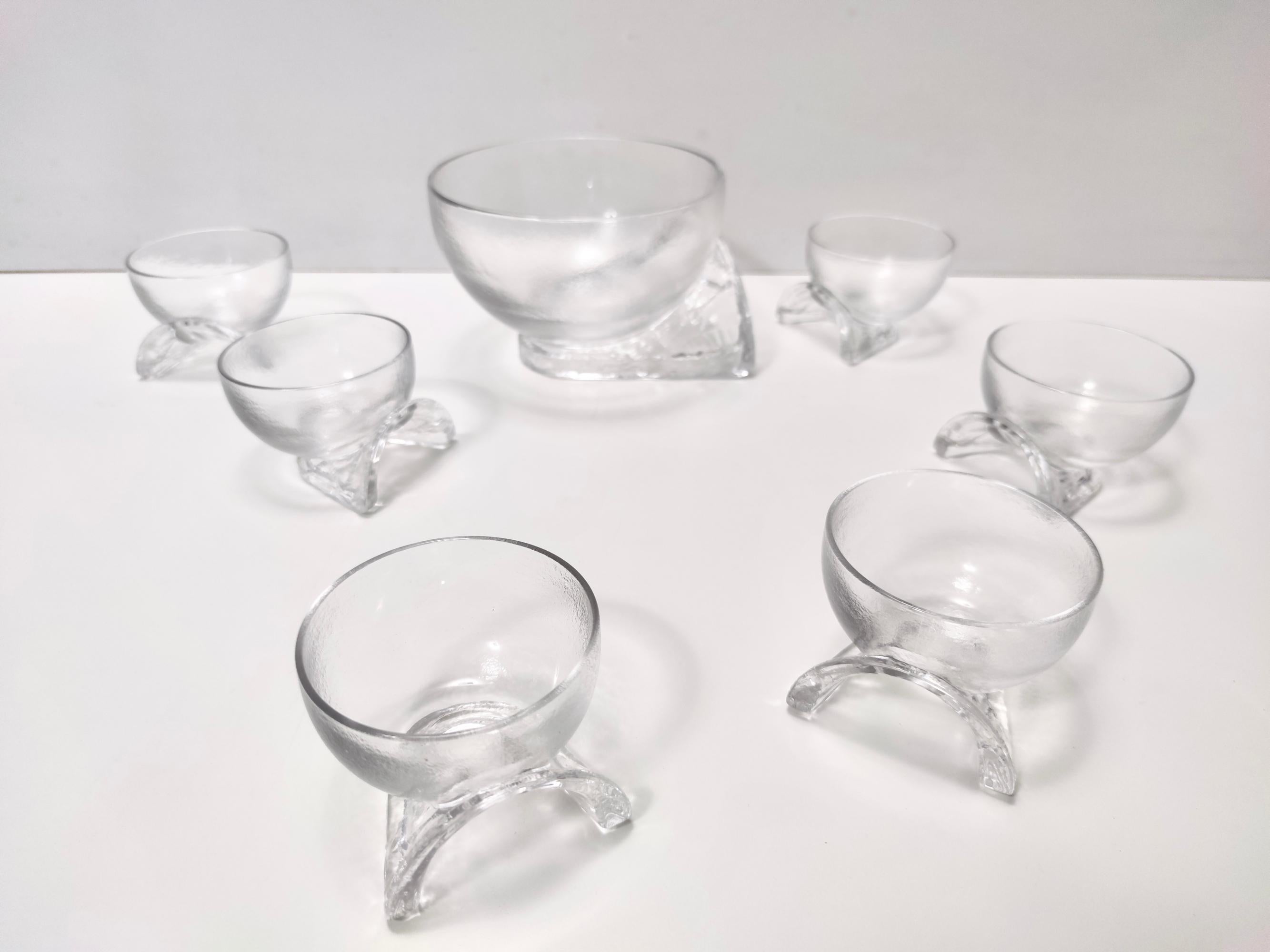Made in Italy, 1970s. 
This is an elegant set of serving bowls, that looks like it's made out of ice.
It has a peculiar grip, as shown in the pictures, that allows to keep one bowl on two fingers. 
This set was designed by the architect Taddei